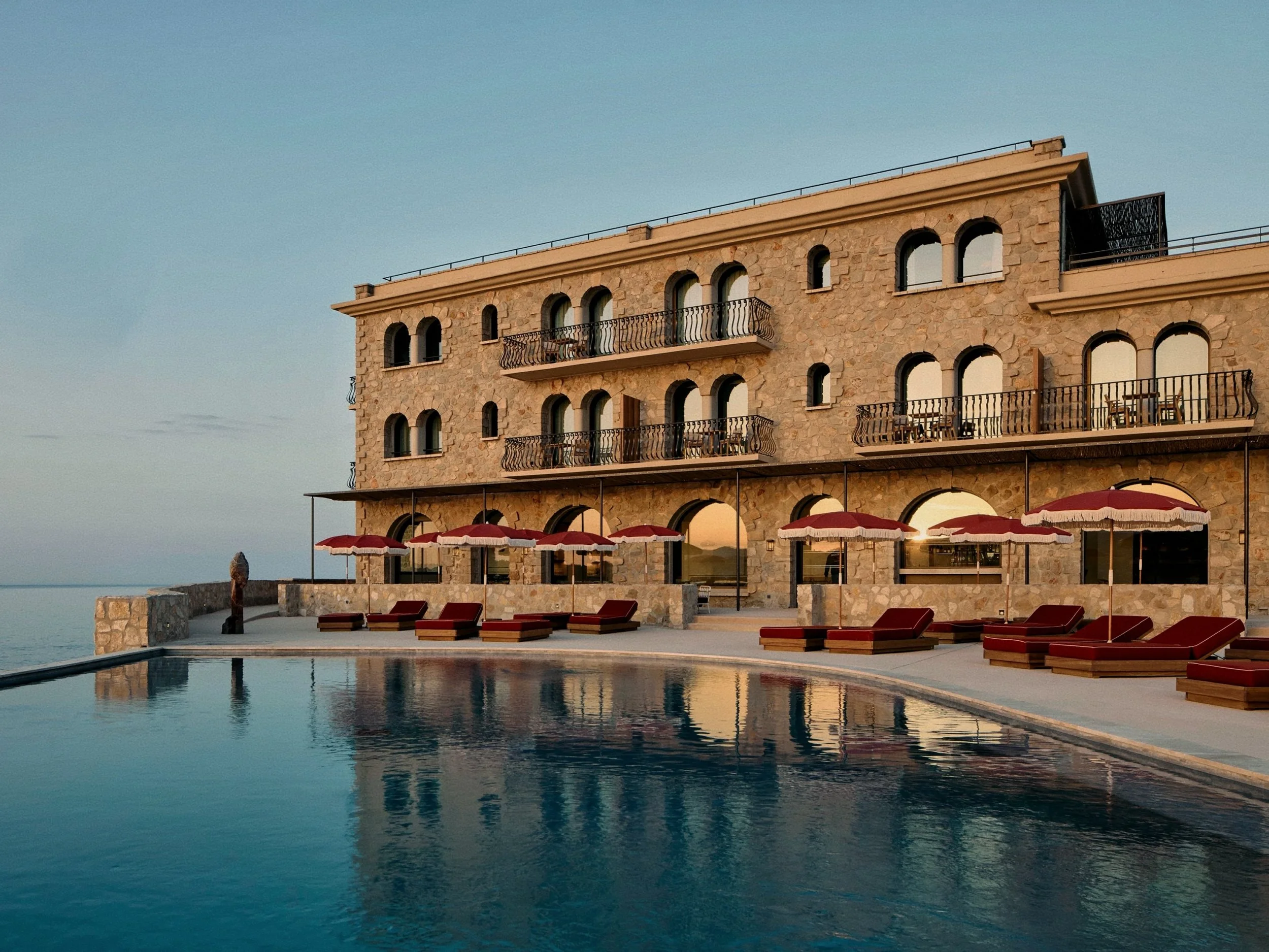 Tiered stone arcades and infinity pool terrace at Zannier Île de Bendor on the Côte d'Azur.