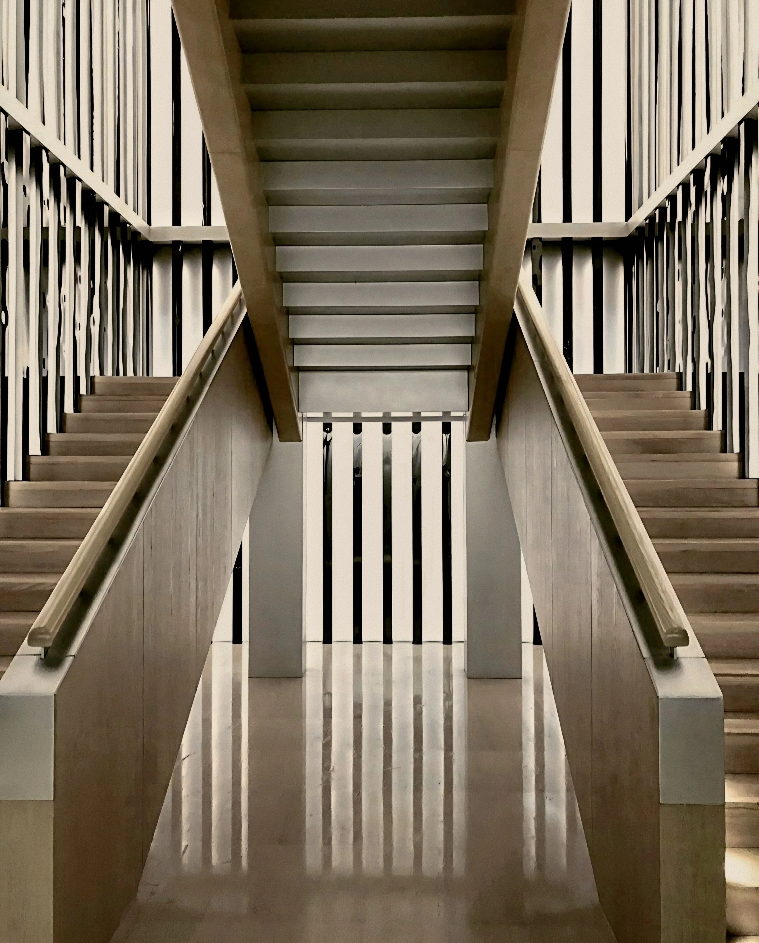 Symmetrical oak staircase and metallic balustrades At The PuXuan Hotel and Spa in Beijing, China.