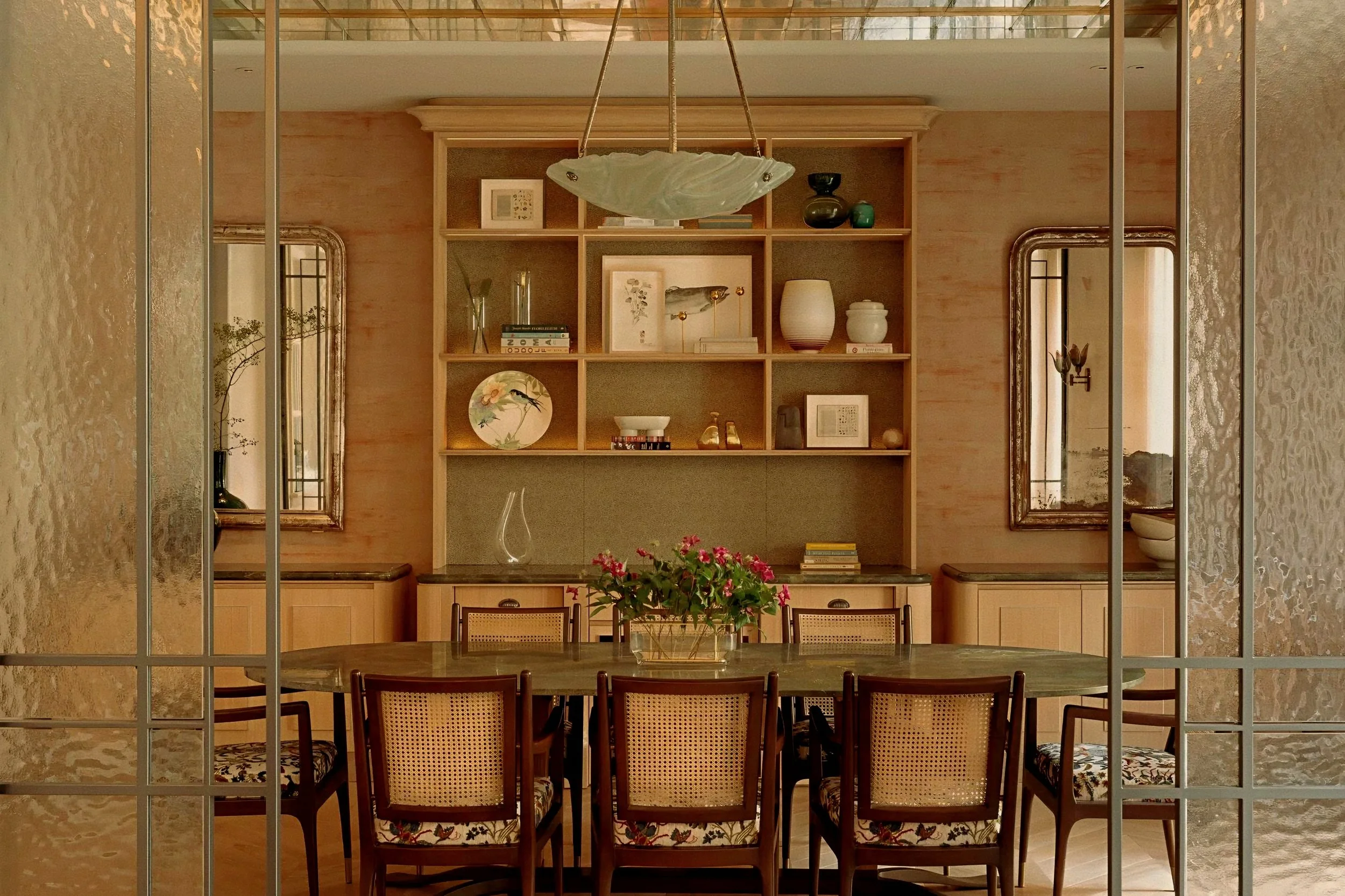 Fluted glass screens and cane chairs at Rosewood Amsterdam a luxury hotel in Netherlands.
