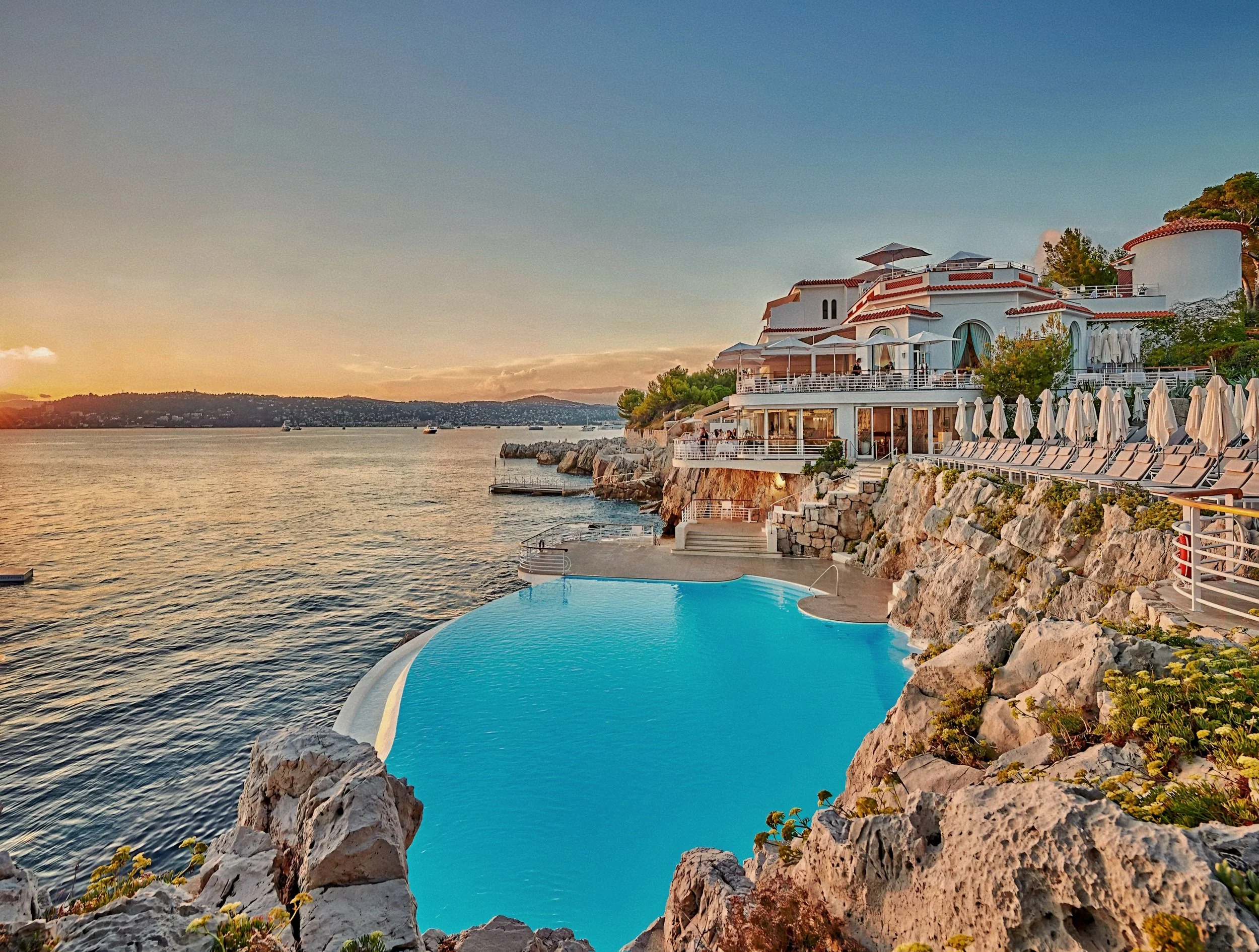 Cliffside saltwater infinity pool carved into rock at Hotel du Cap-Eden-Roc in Antibes, France on the French Riviera.