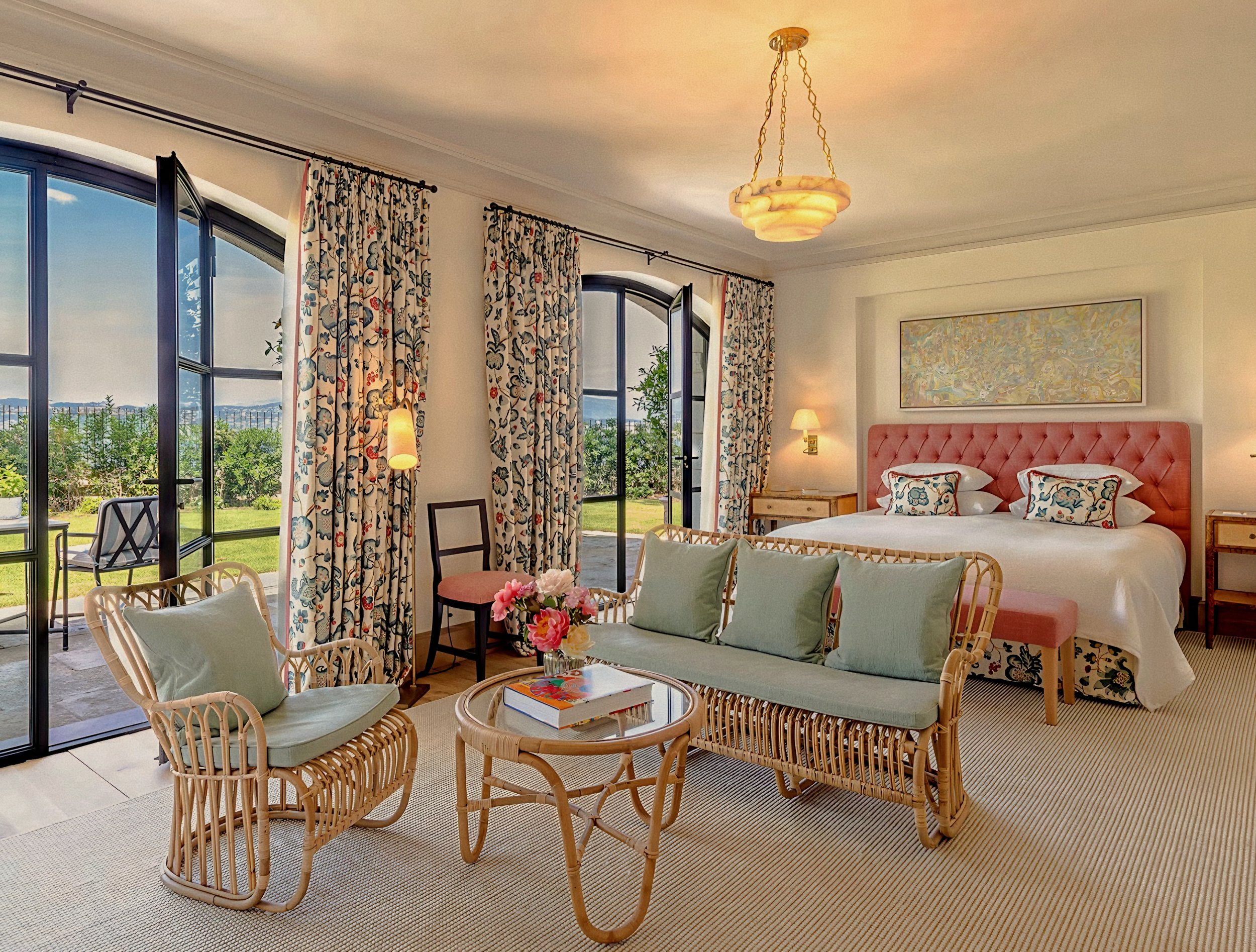 Rattan seating and floral drapery inside a suite at Hotel du Cap-Eden-Roc in Antibes, France on the French Riviera Côte d'Azur.