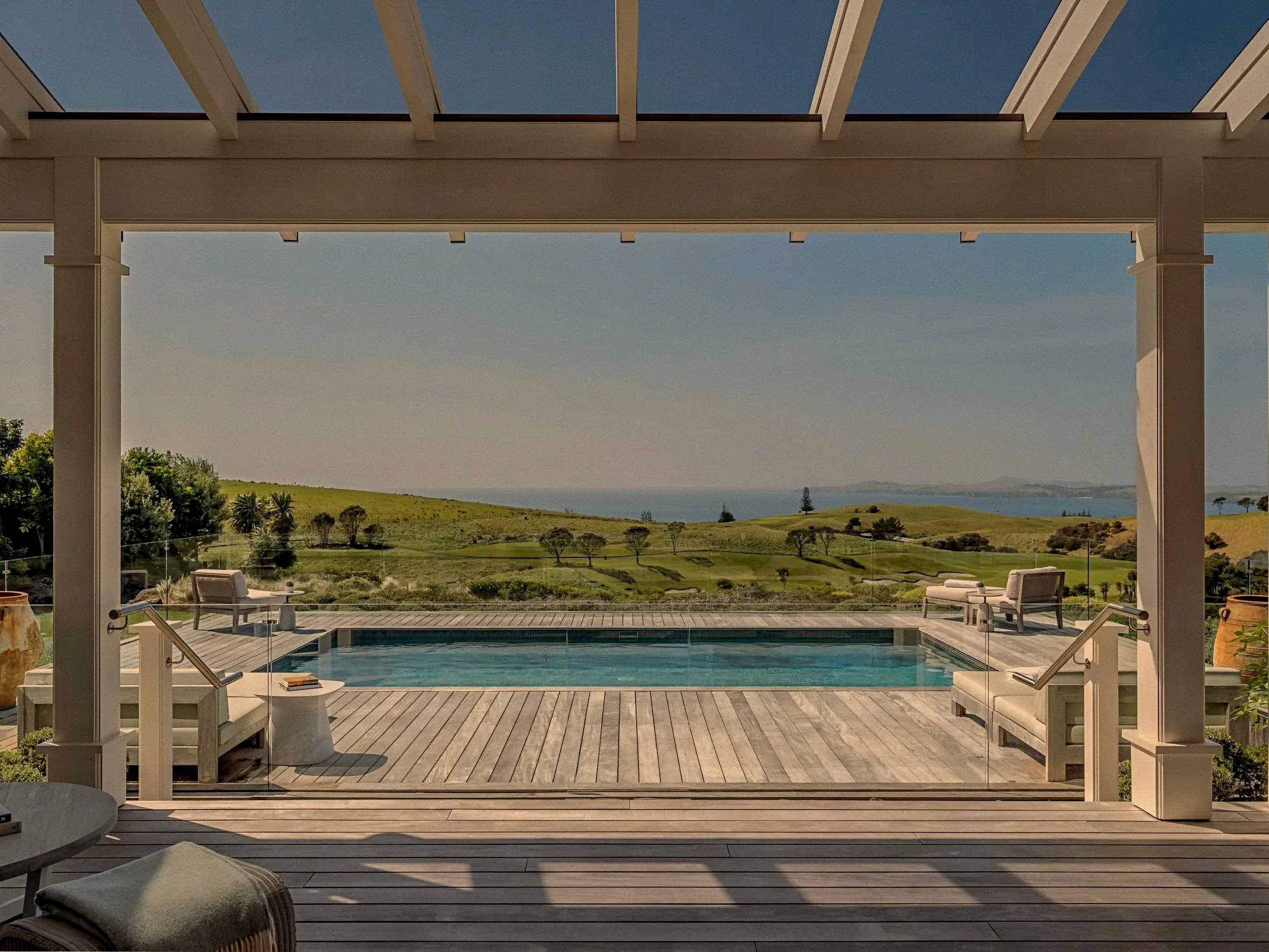 Timber pergola and private infinity pool deck at Rosewood Kauri Cliffs, Matauri Bay, New Zealand.