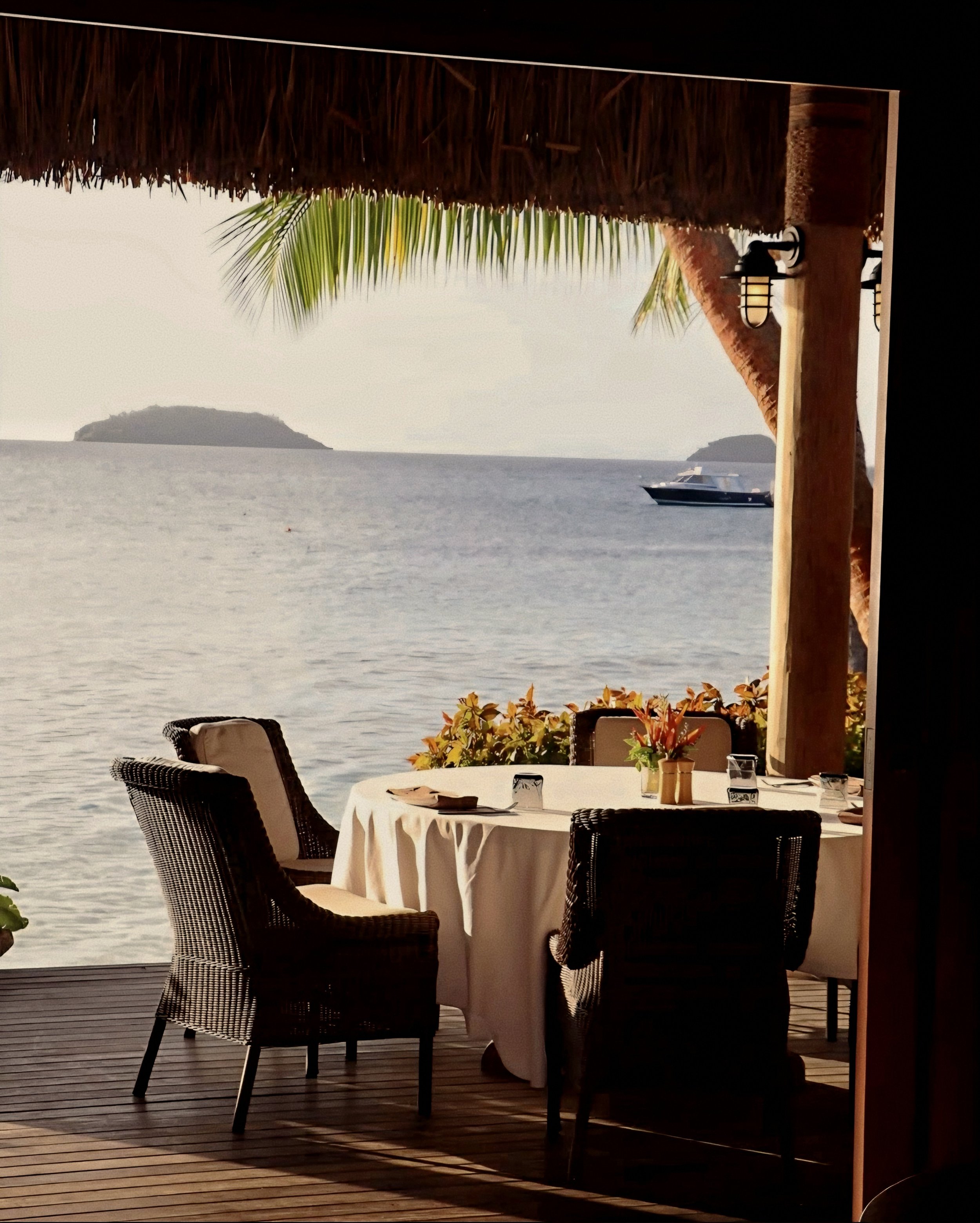 Ocean-facing dining loggia overlooking the Kadavu passage at Kokomo Private Island, South Pacific.