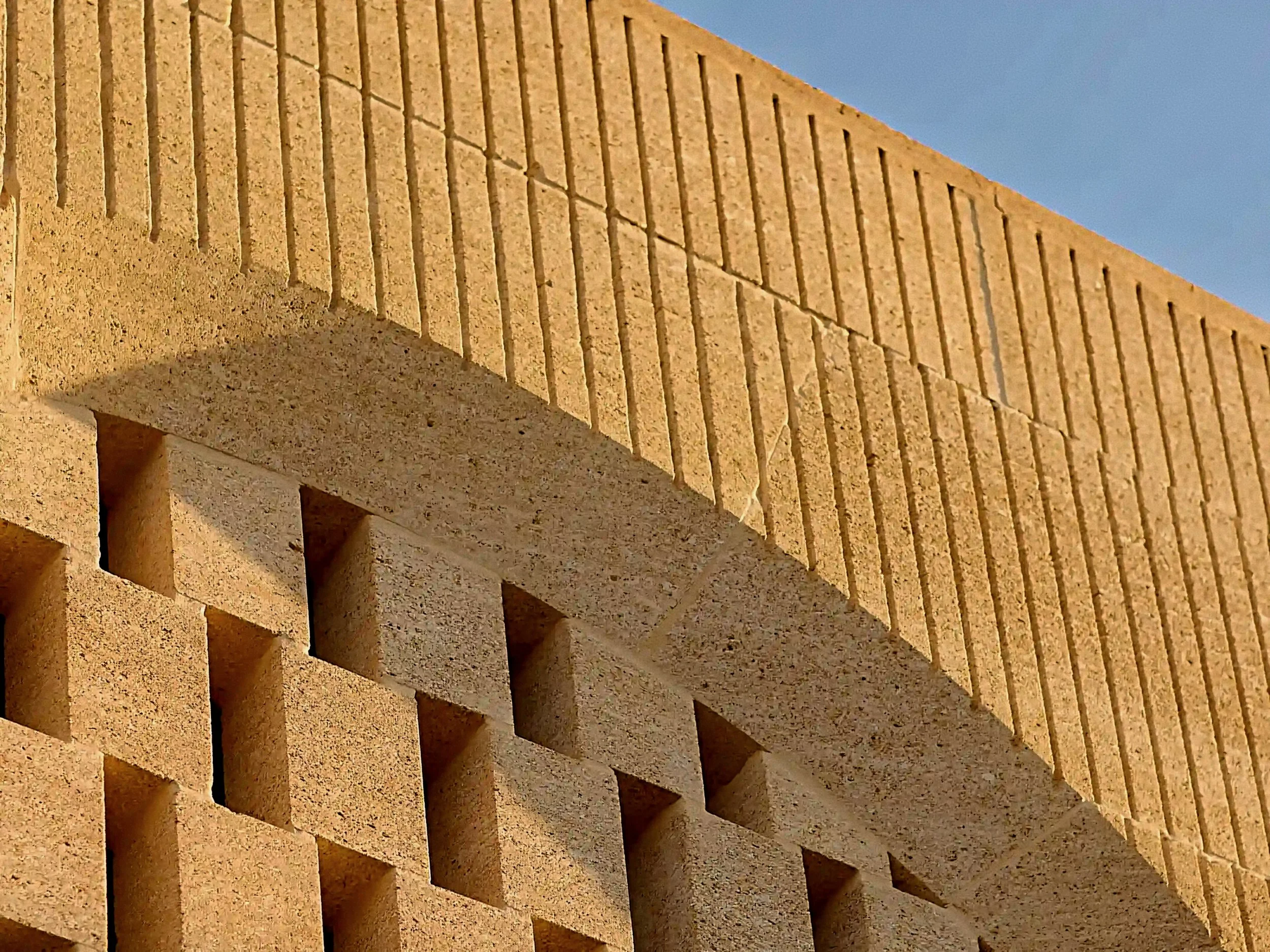 Fluted limestone masonry and carved architectural details at Zannier Île de Bendor resort.
