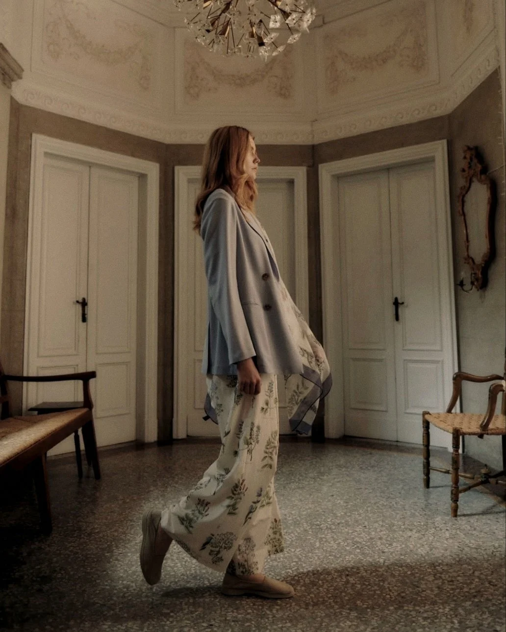 Fluid silk-cashmere tailoring by Lanificio Colombo set against polished Venetian terrazzo flooring in an Italian villa.