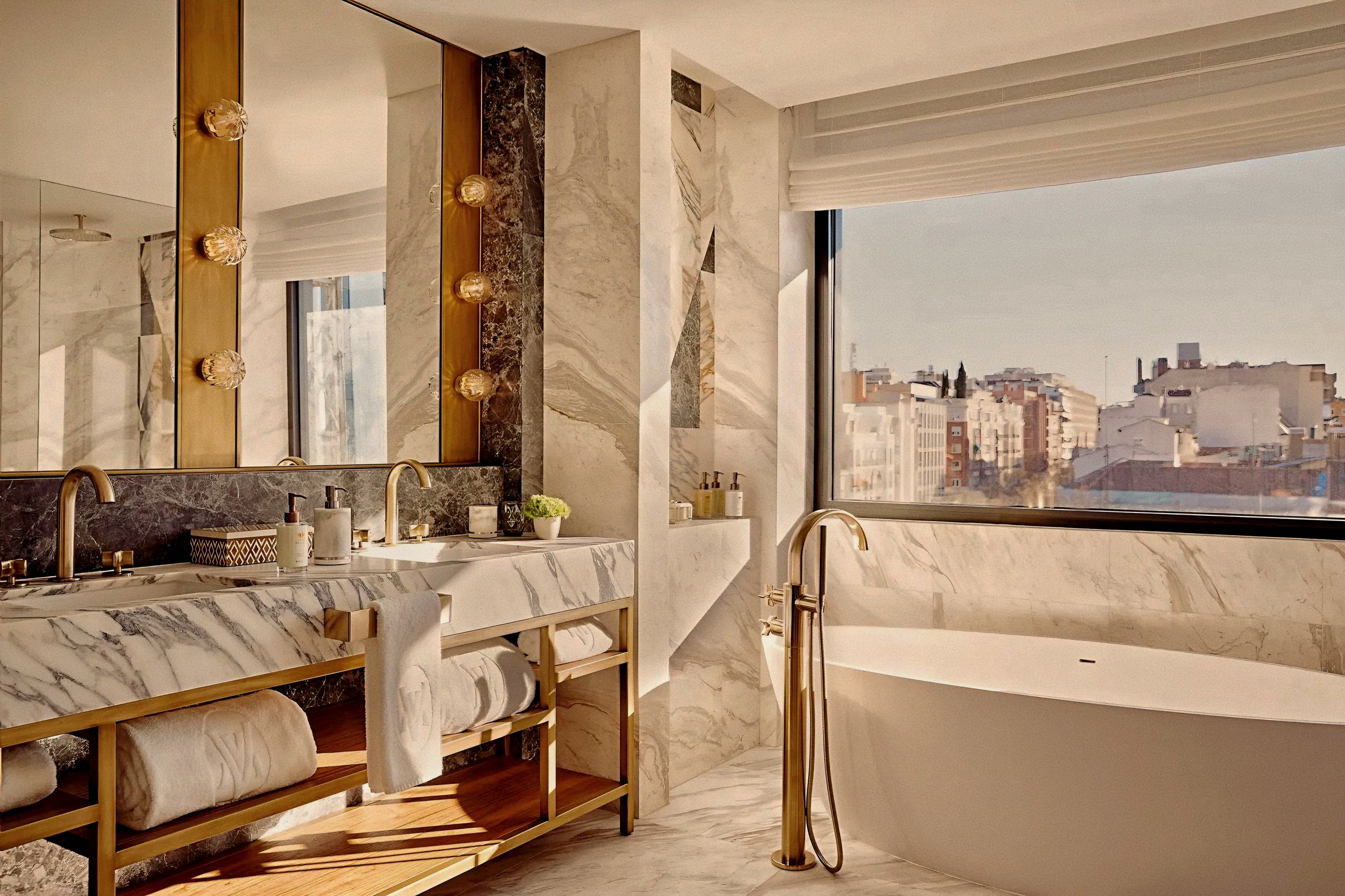 Luxury marble bathroom with deep tub at Rosewood Villa Magna Salamanca Madrid Spain overlooking city views.