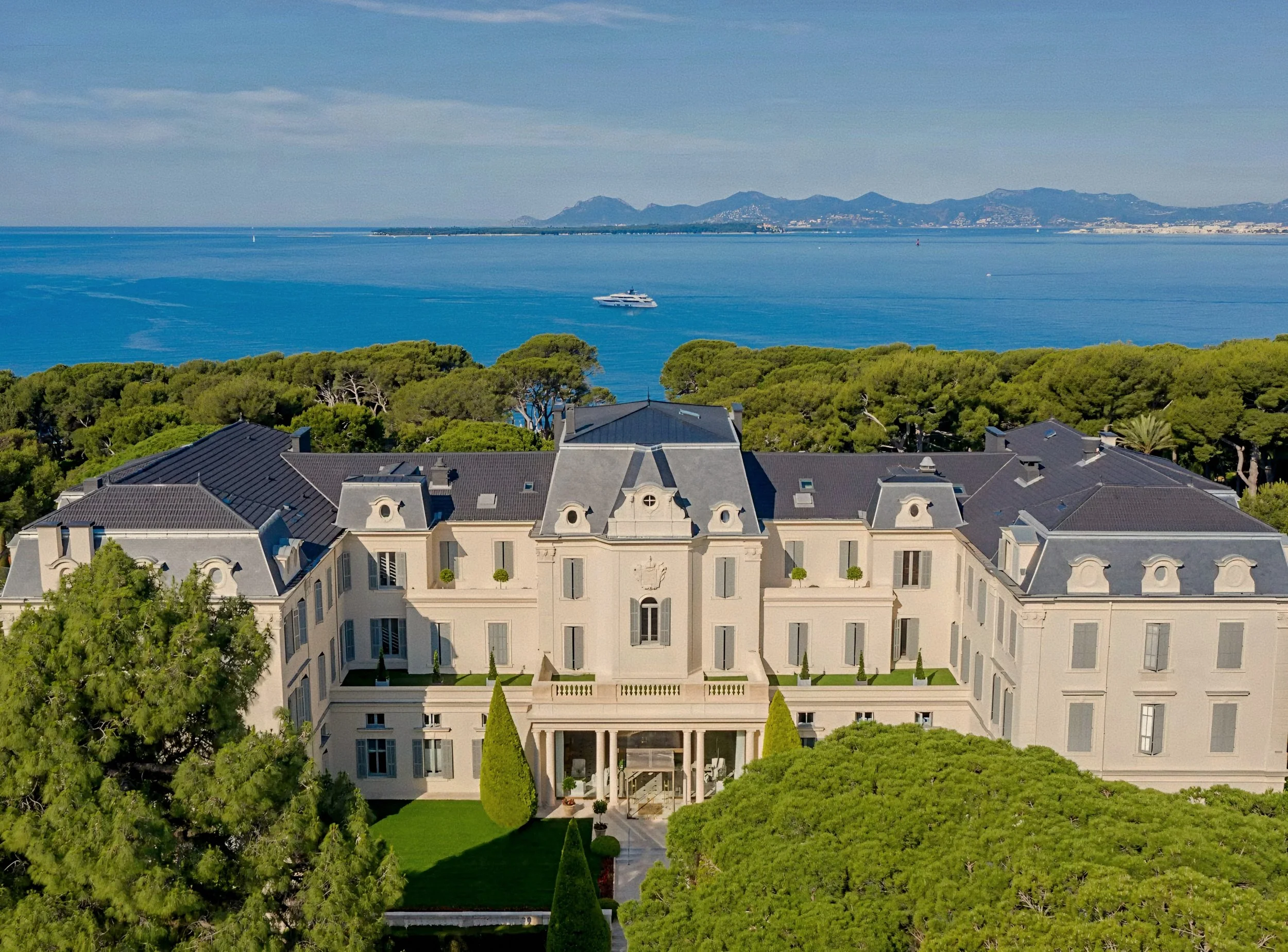 Historic Grande Dame mansion facade at Hotel du Cap-Eden-Roc, a luxury hotel in Antibes, France on the French Riviera.