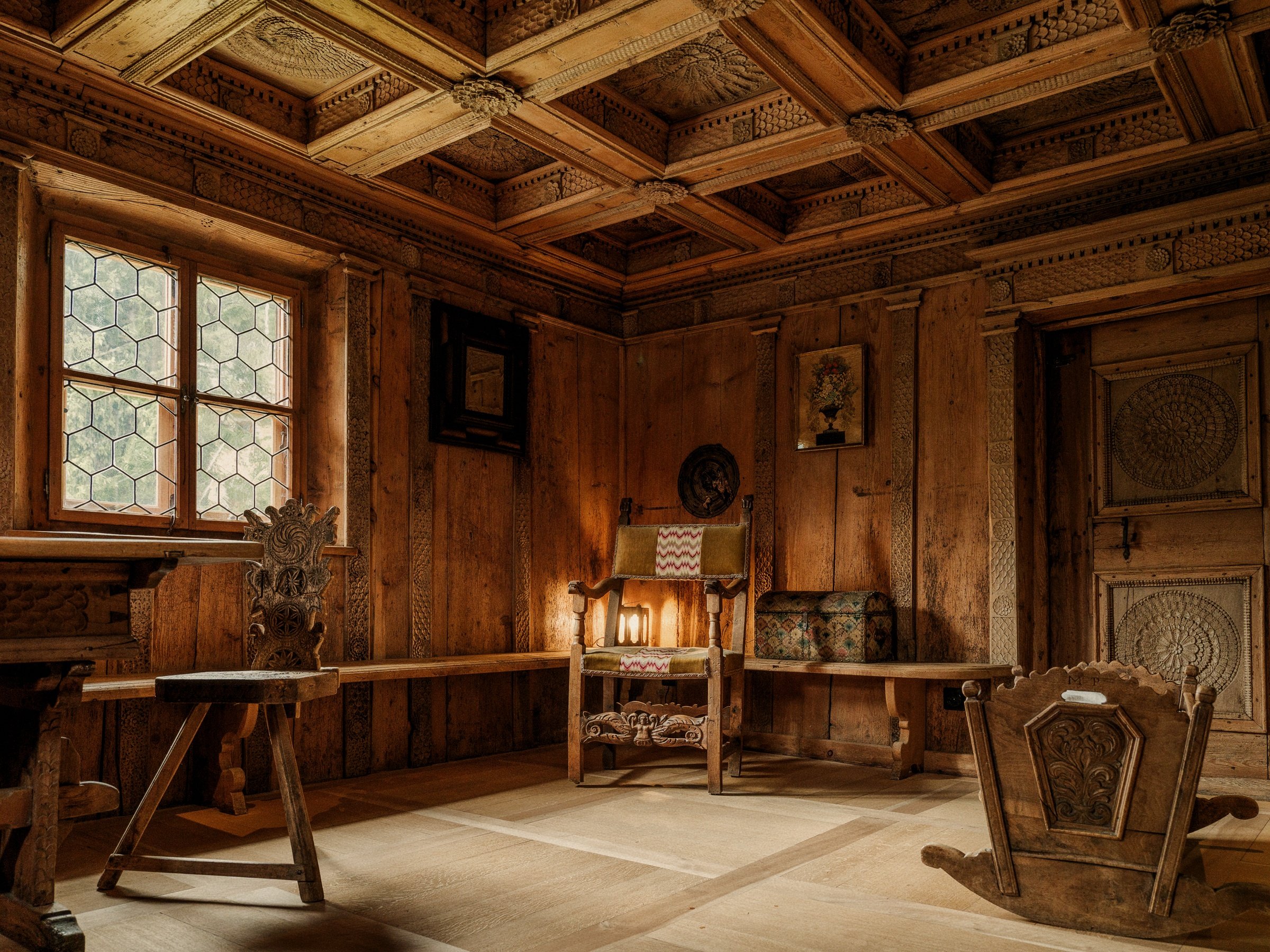 Traditional Swiss Engadine Stube framed in historic aged pine panelling at Chesa Marchetta, Switzerland.