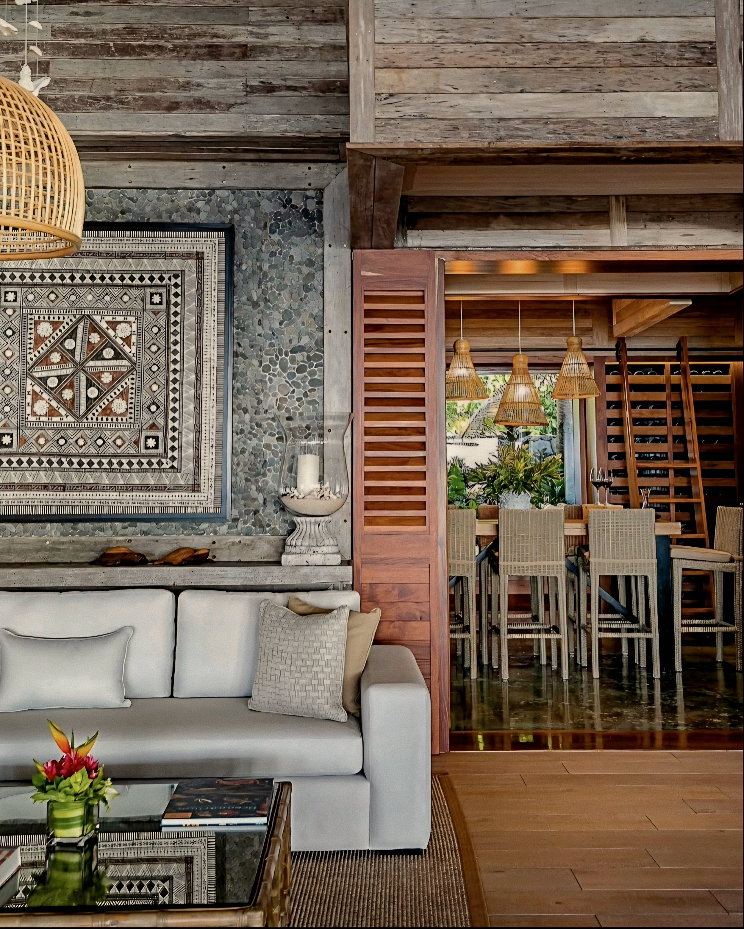 Luxury villa salon lined in river-stone masonry at Kokomo Private Island, Fiji Islands.