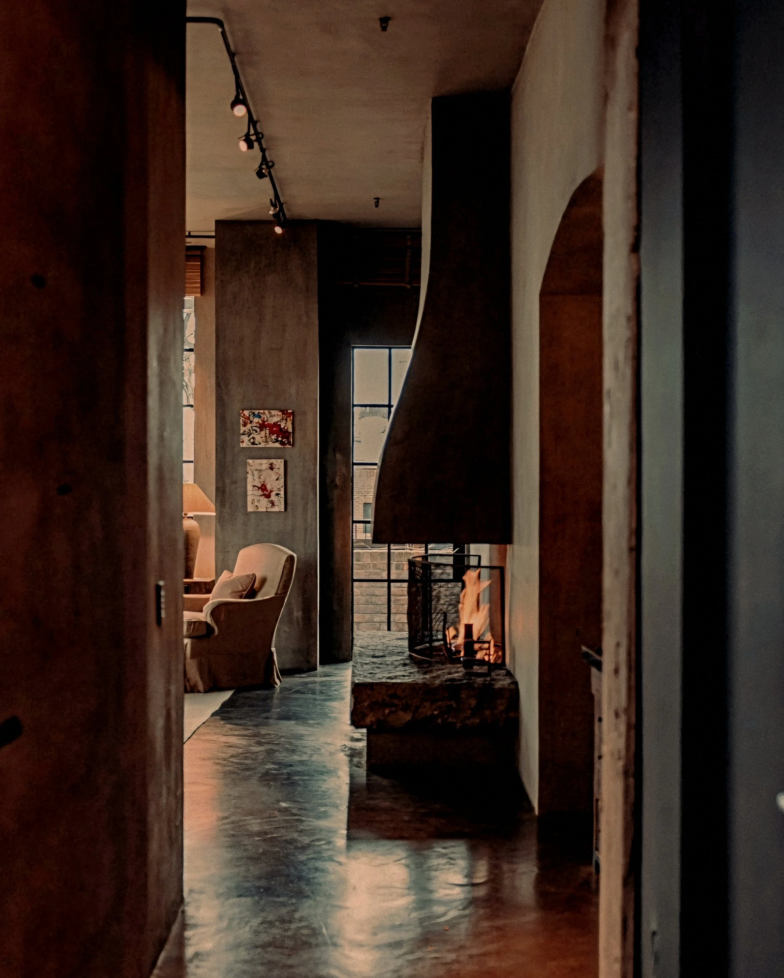 Earth-toned gallery and hearth designed by Axel Vervoordt at The Greenwich Hotel TriBeCa penthouse, New York.