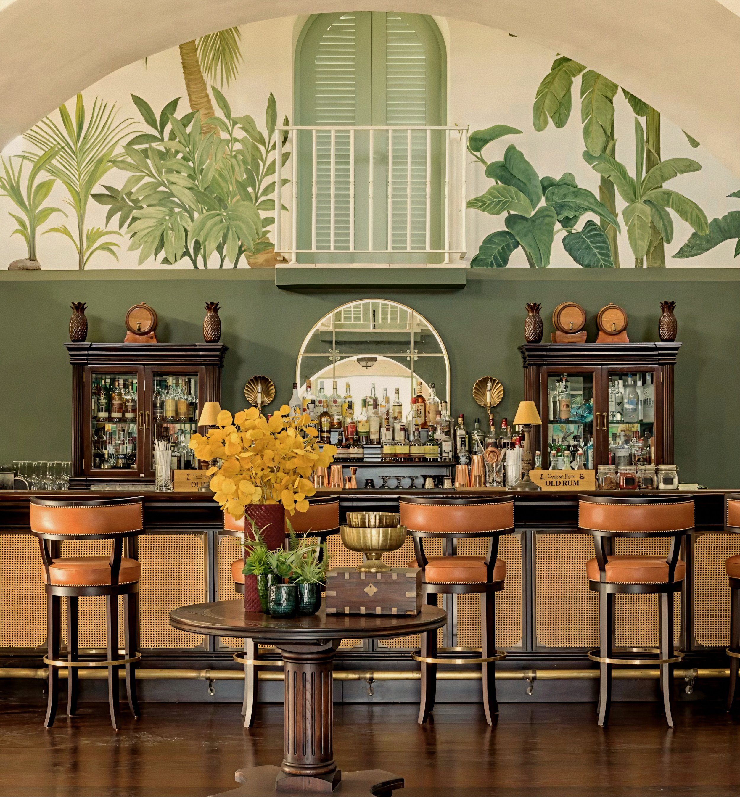 Historic stone bar with botanical murals at Jumby Bay luxury private island, Antigua.