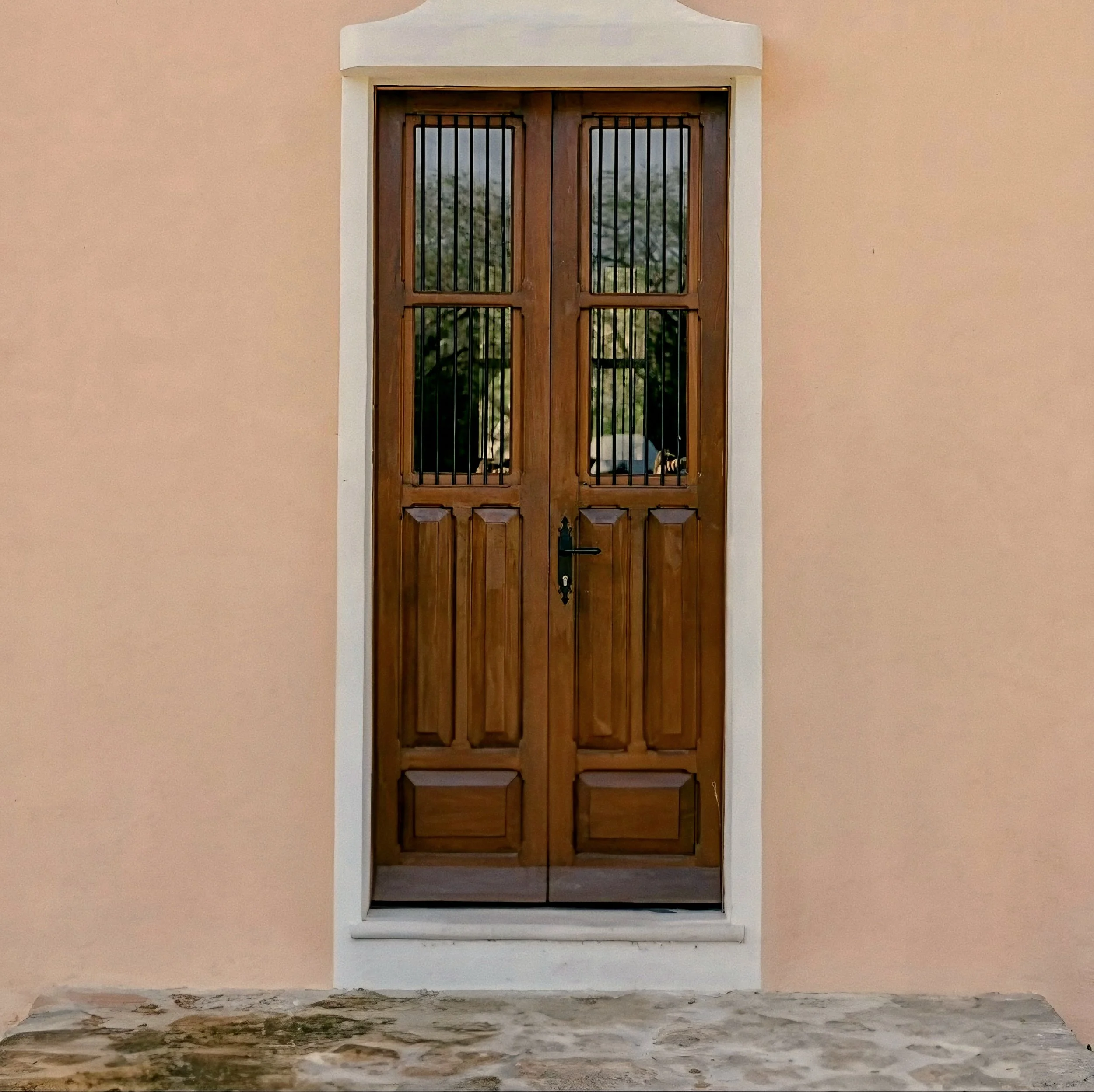 Carved dark timber entry door and terracotta wall at Hacienda Chablé Yucatán, Chocholá, Mexico.
