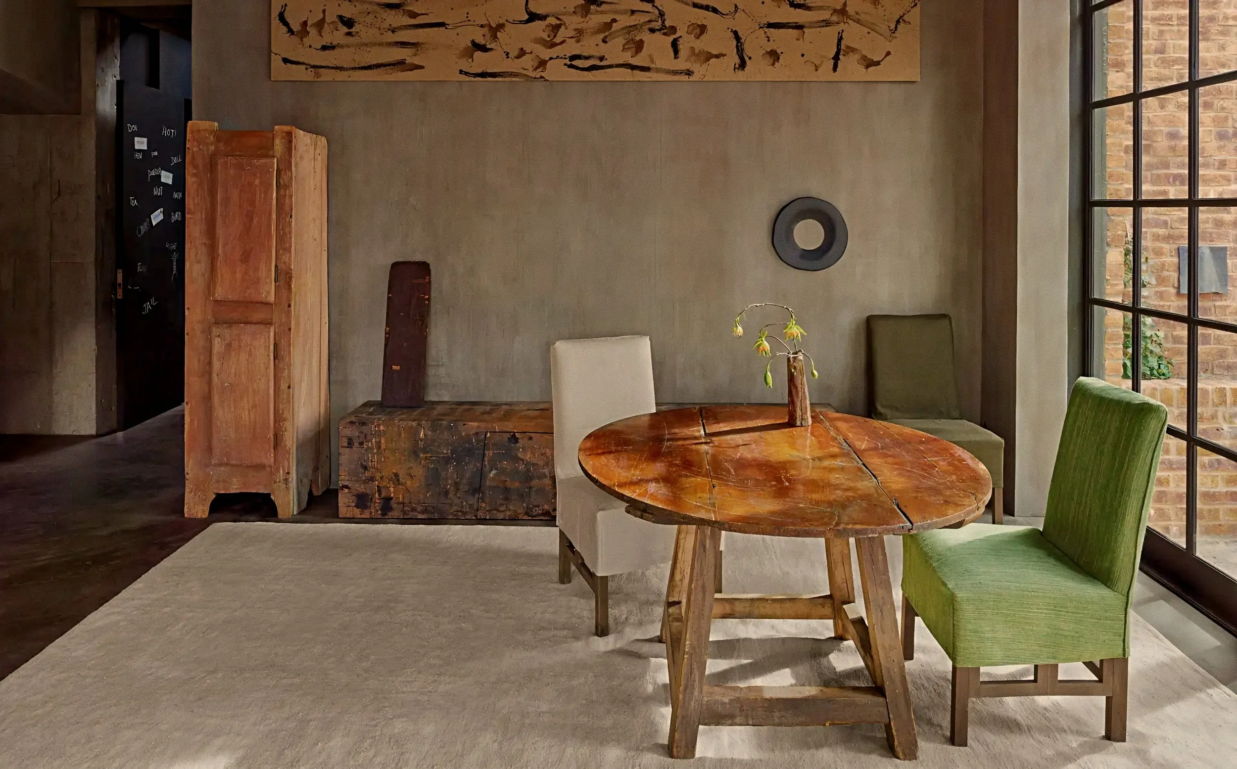 Intimate dining alcove framed by reclaimed timber in the Axel Vervoordt TriBeCa penthouse, New York.