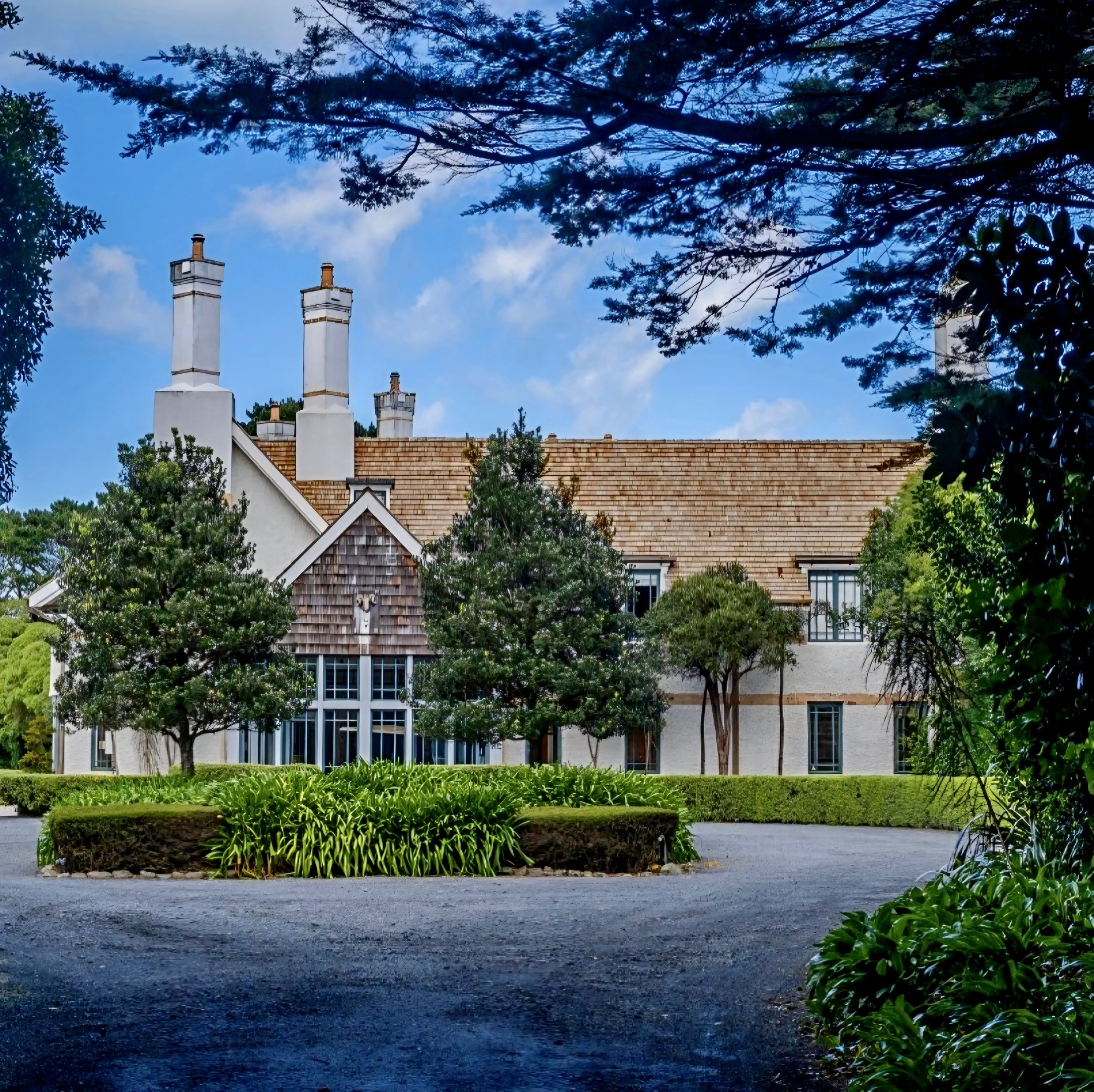 Main manor house exterior facade at Wharekauhau Country Estate luxury lodge, Palliser Bay, New Zealand.