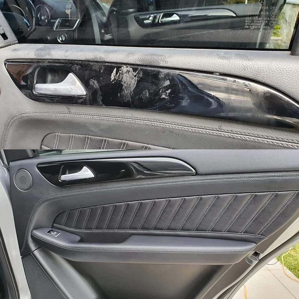 Car door interior showing damage and dirt near the window, with visible door handle, speaker, and window control buttons.