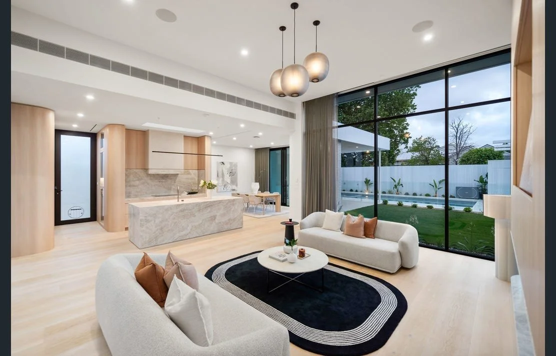 Modern open-concept living room with round pendant lights.