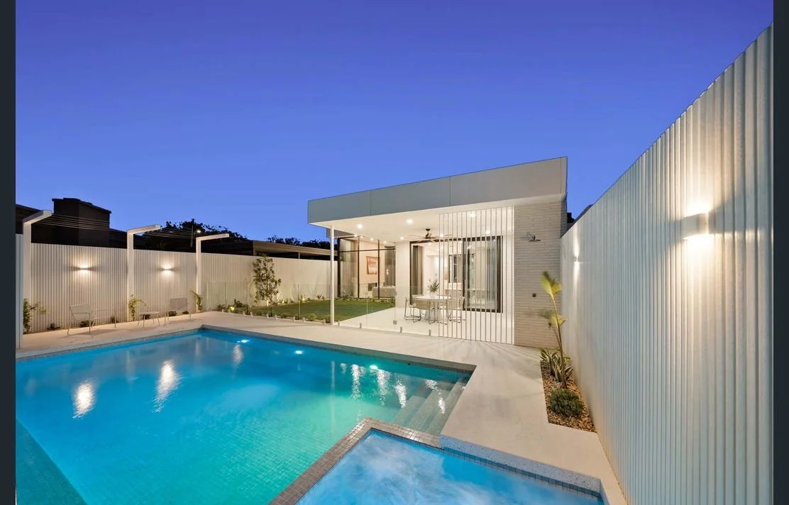 Modern backyard with a swimming pool lighting.