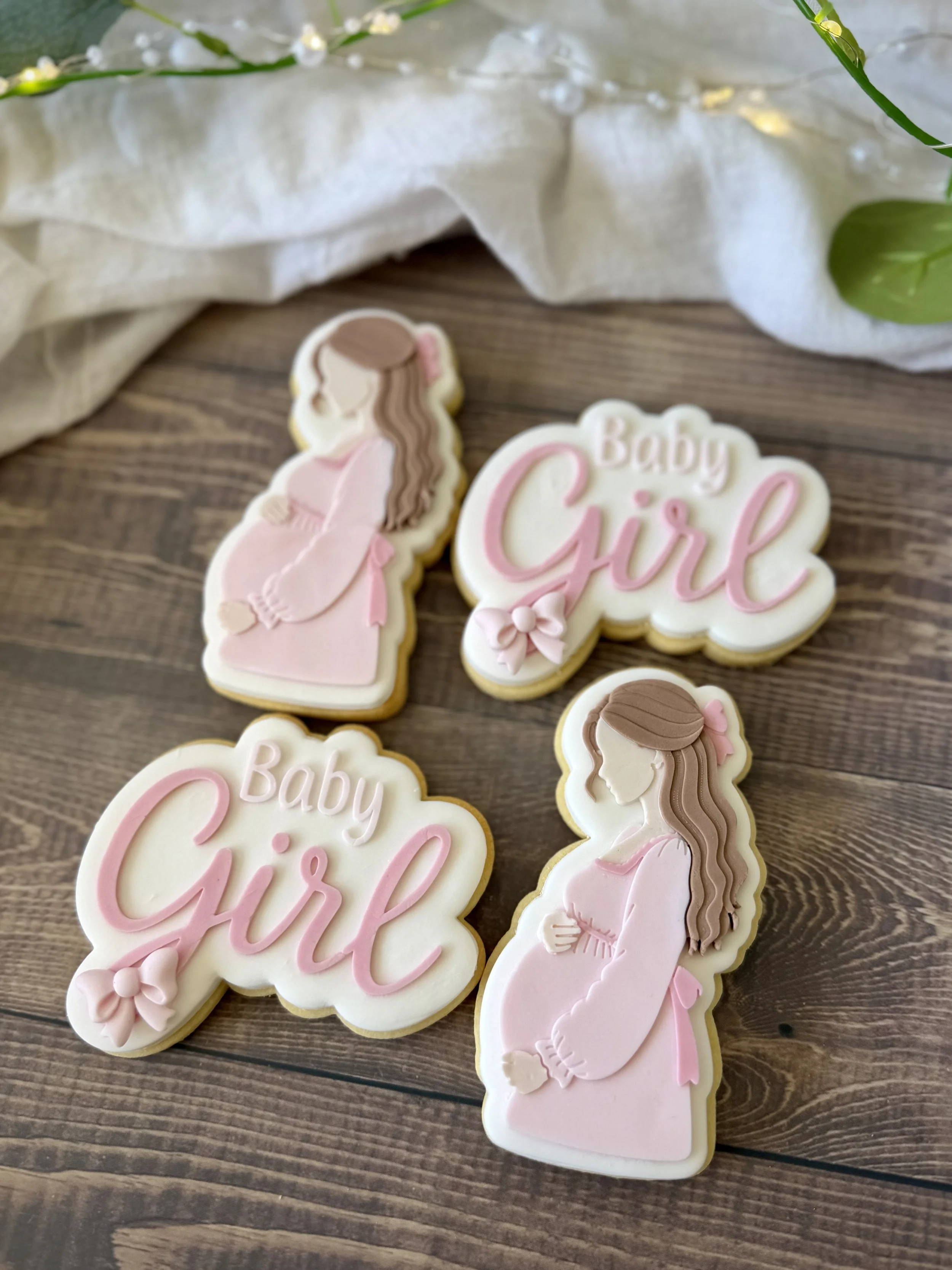 Handmade vanilla sugar cookies decorated with layered pink and white fondant, featuring a beautiful mum-to-be and Baby Girl lettering. Perfect for baby showers and pregnancy celebrations.