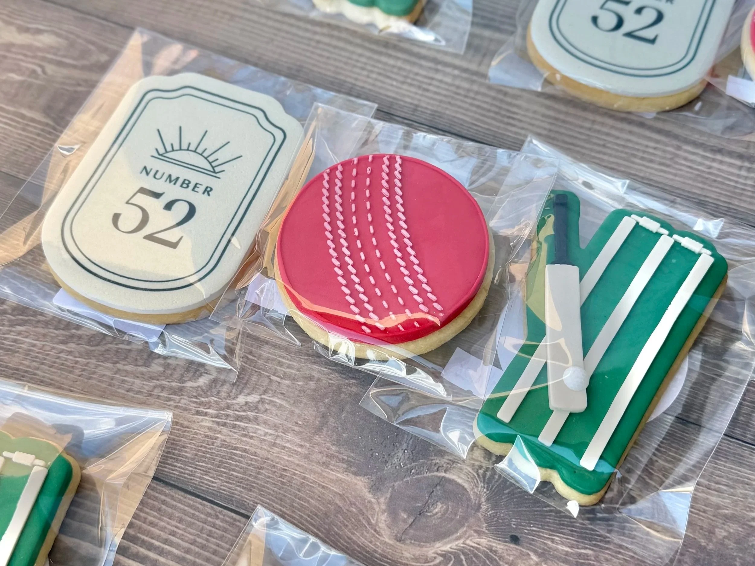 Personalised edible image cookies for No. 52, Sir Donald Bradman's childhood home in Bowral, featuring a cricket ball, wicket and golf ball