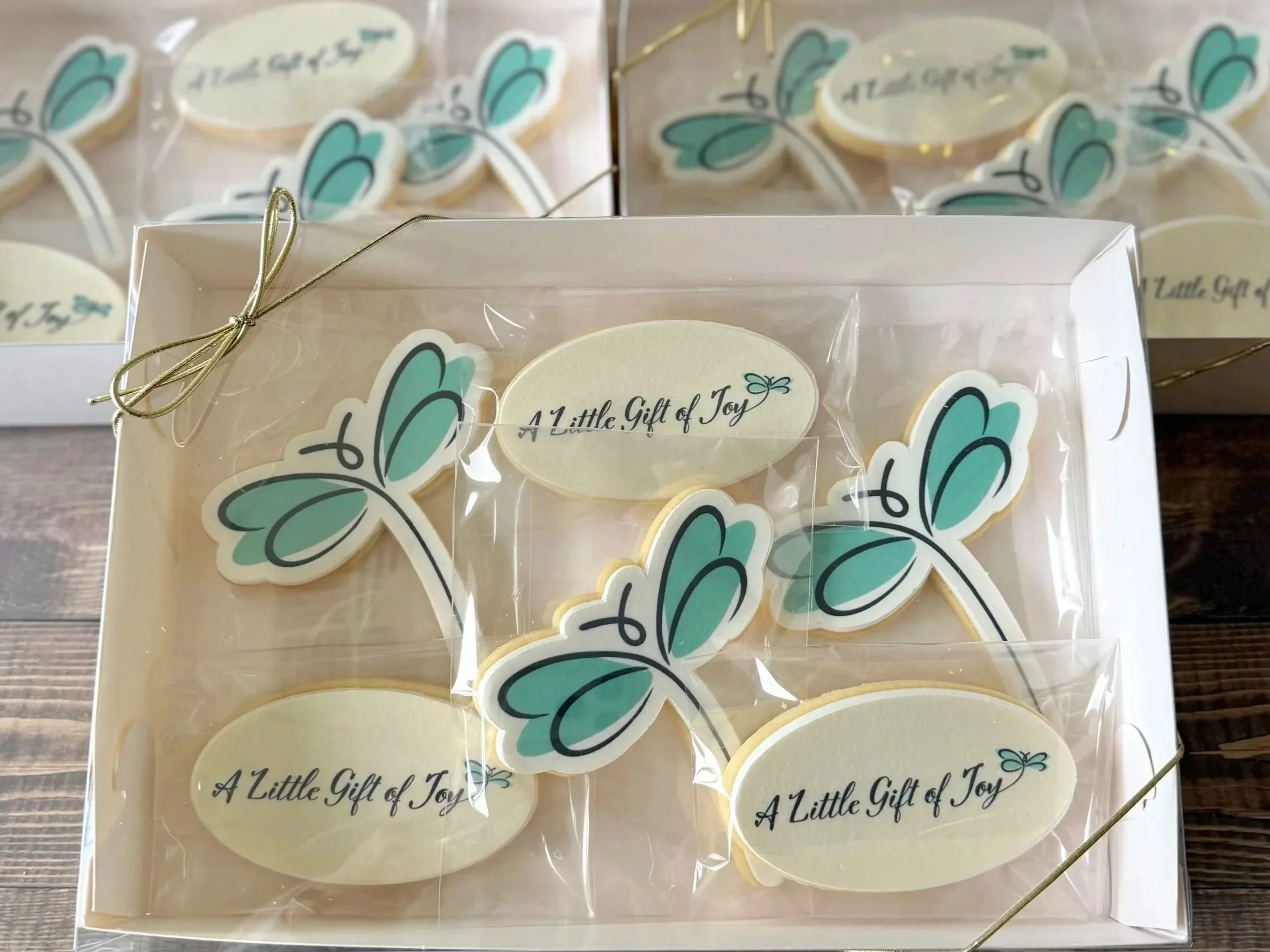Custom edible image cookies featuring the new A Little Gift of Joy dragonfly logo
