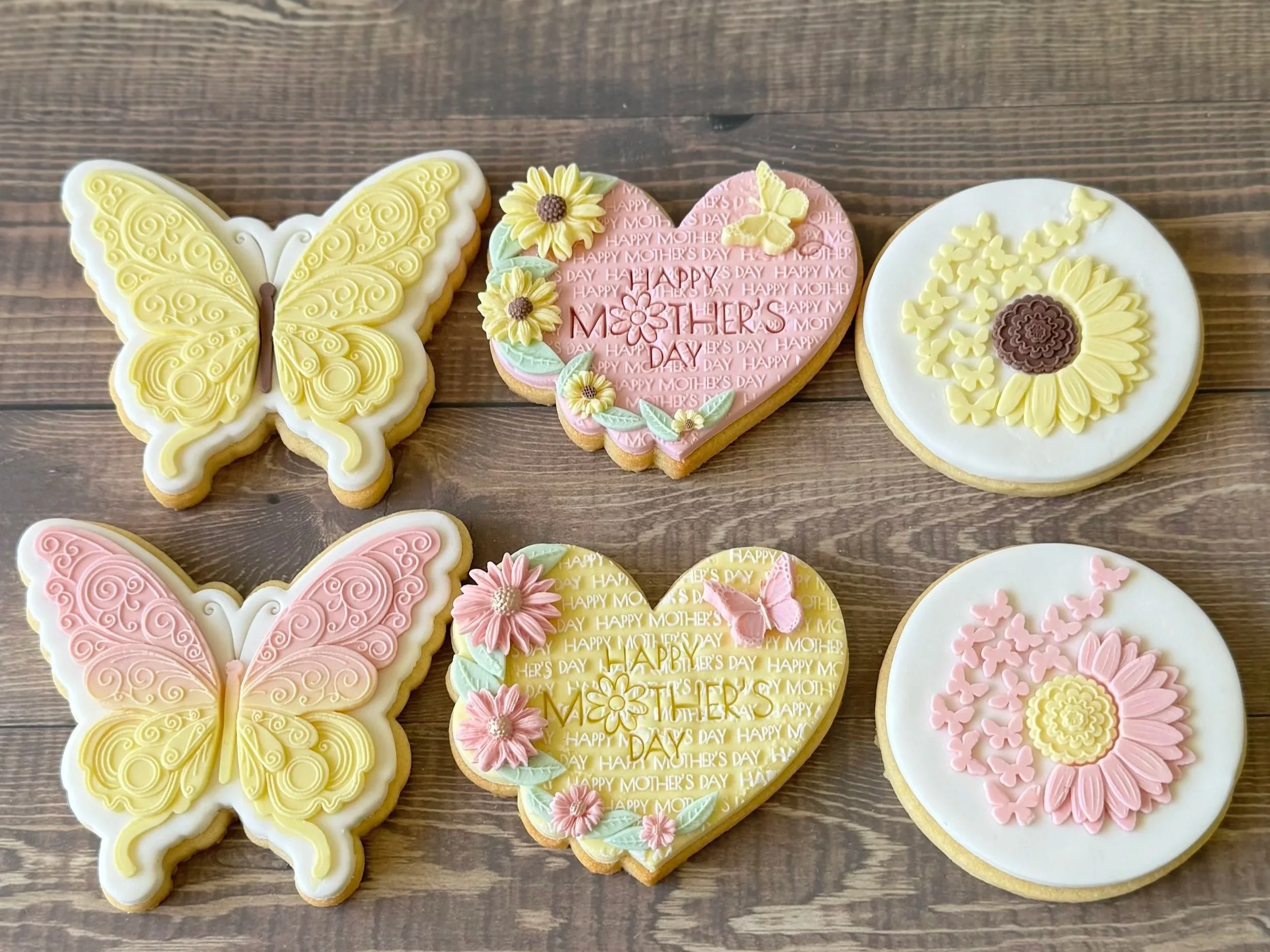Decorated cookies with flowers, butterflies, and a sunflower of butterflies