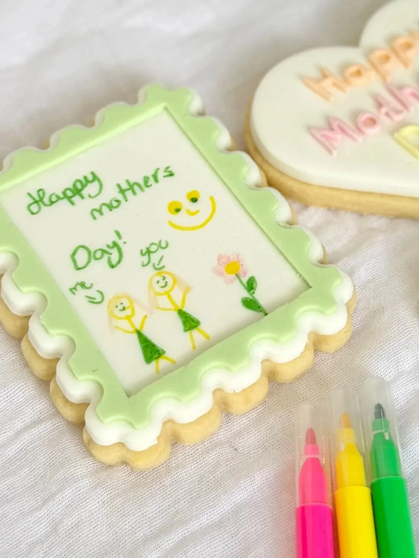 Decorated cookies with Mother's Day messages, colourful icing, along with coloured edible ink markers