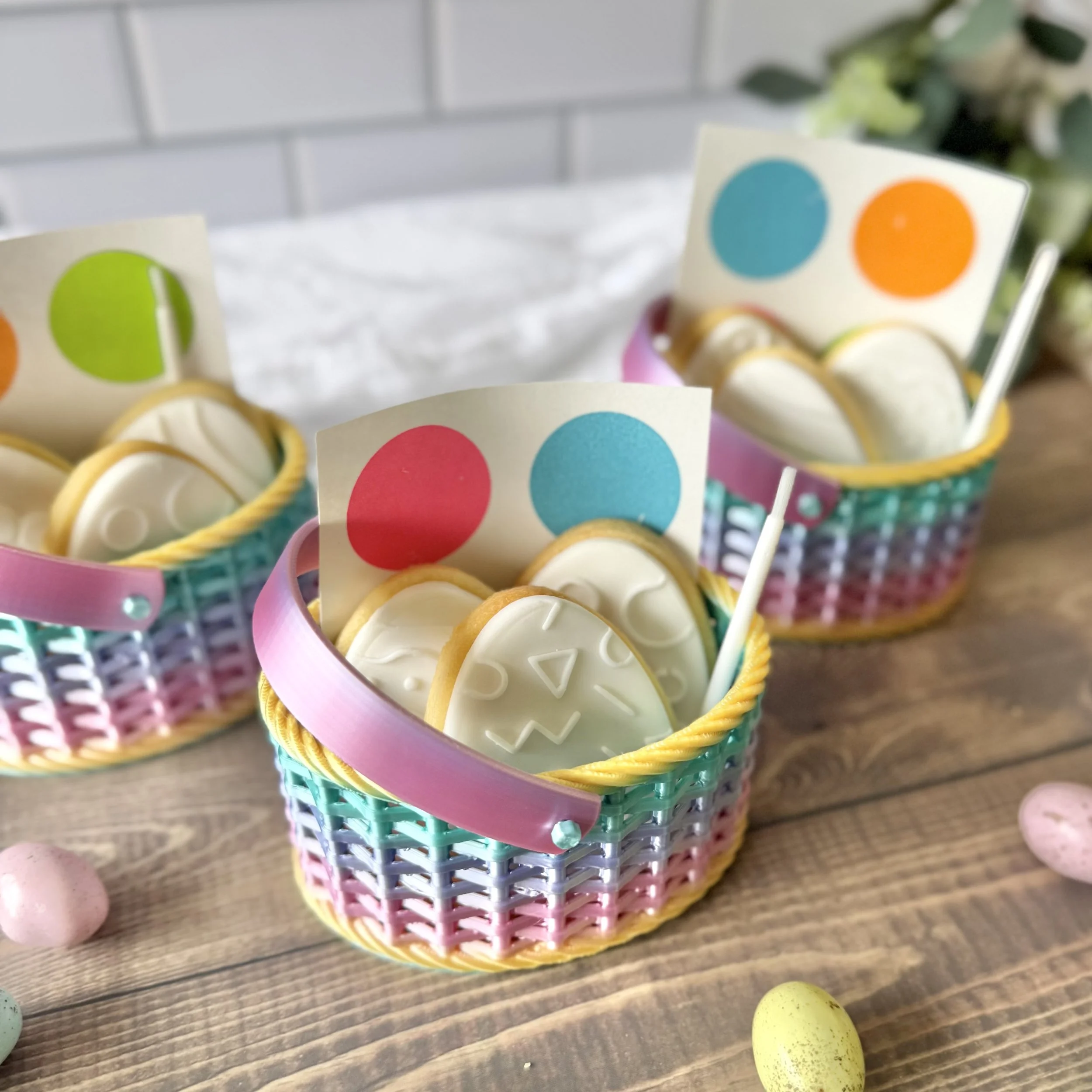 Colourful 3D printed Easter basket, featuring Paint Your Own cookies, with a paint palette and brush
