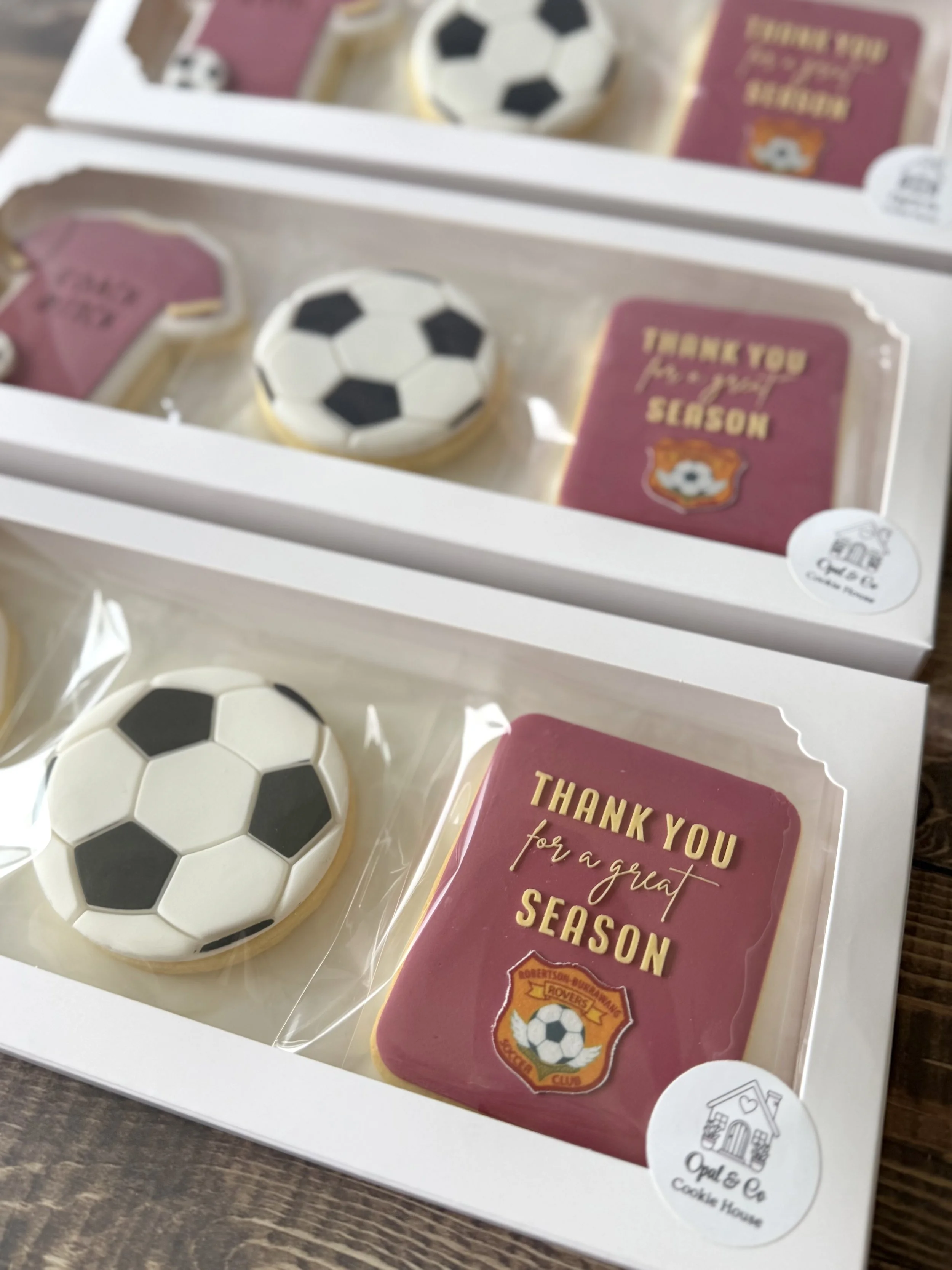 Coach appreciation cookie packs in a clear plastic box with a green ribbon, featuring a cookie with the words "Thank you for a great season" 