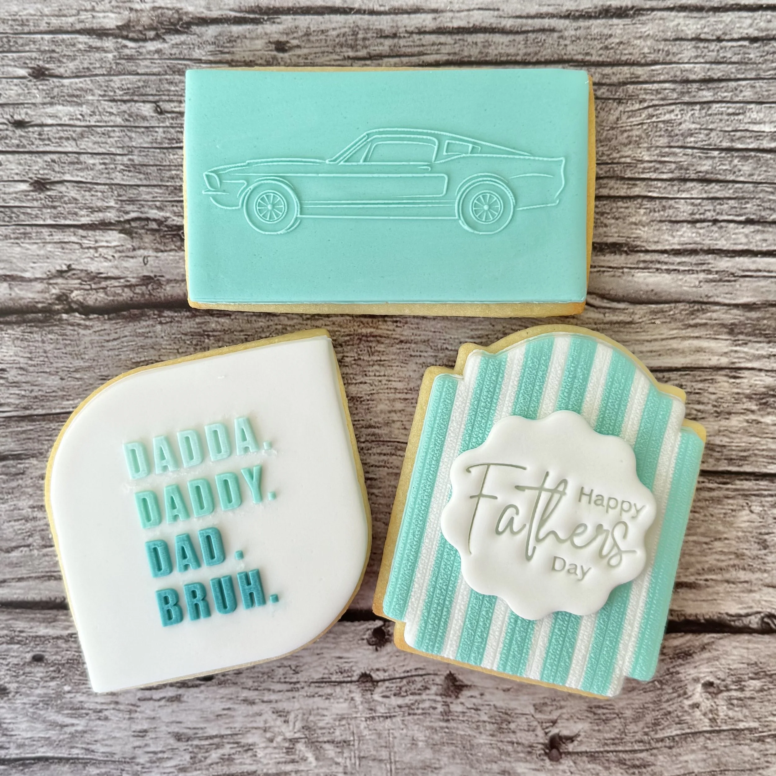 Father's Day cookies with an outline of a car, Happy Father's Day and a message 'Dadda, Daddy, Dad, Bruh'