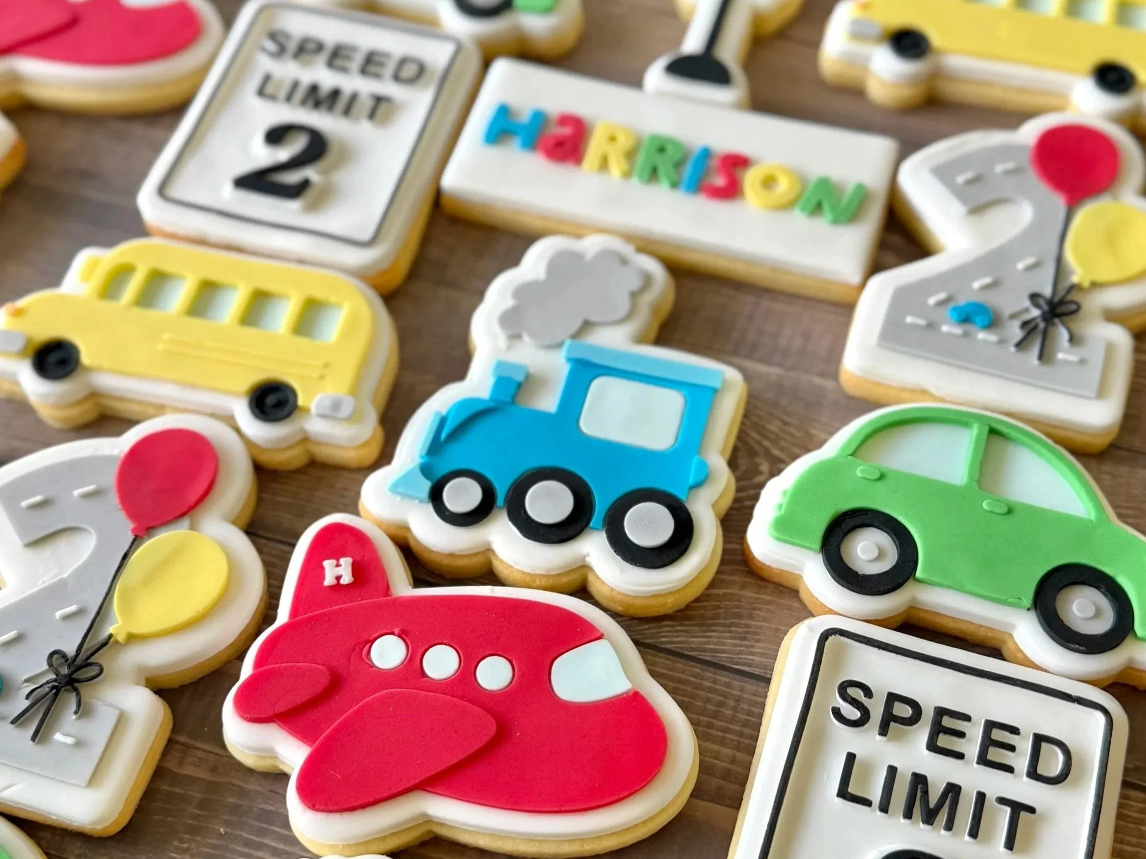 Colourful personalised traffic and transport-themed cookies for a birthday