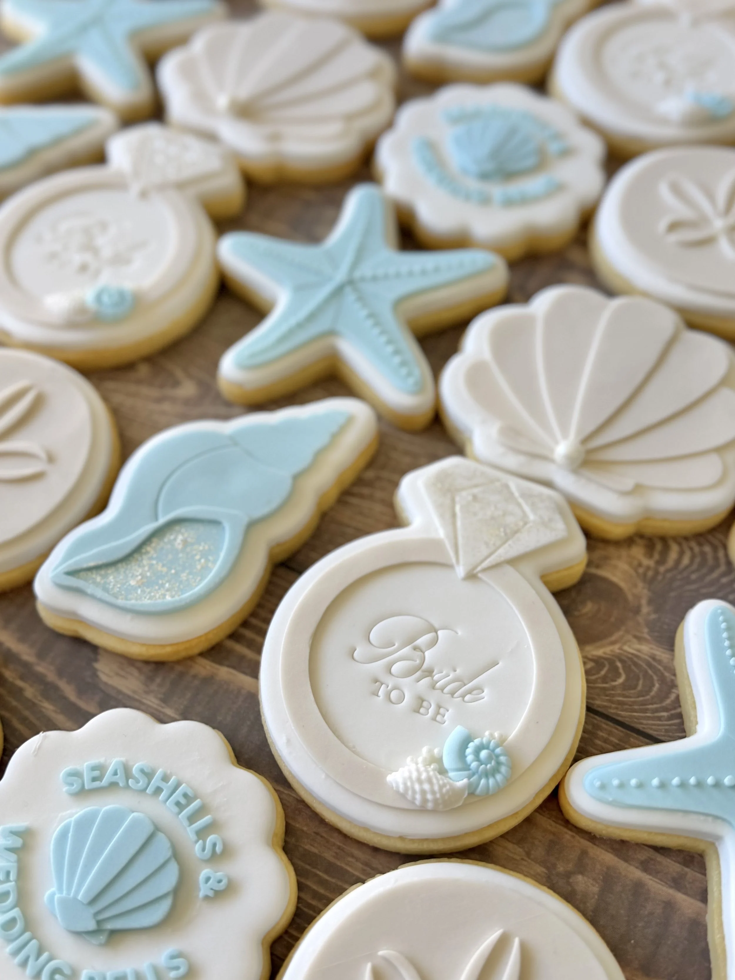 beach coastal bridal shower cookies. bride to be, seashells and wedding bells