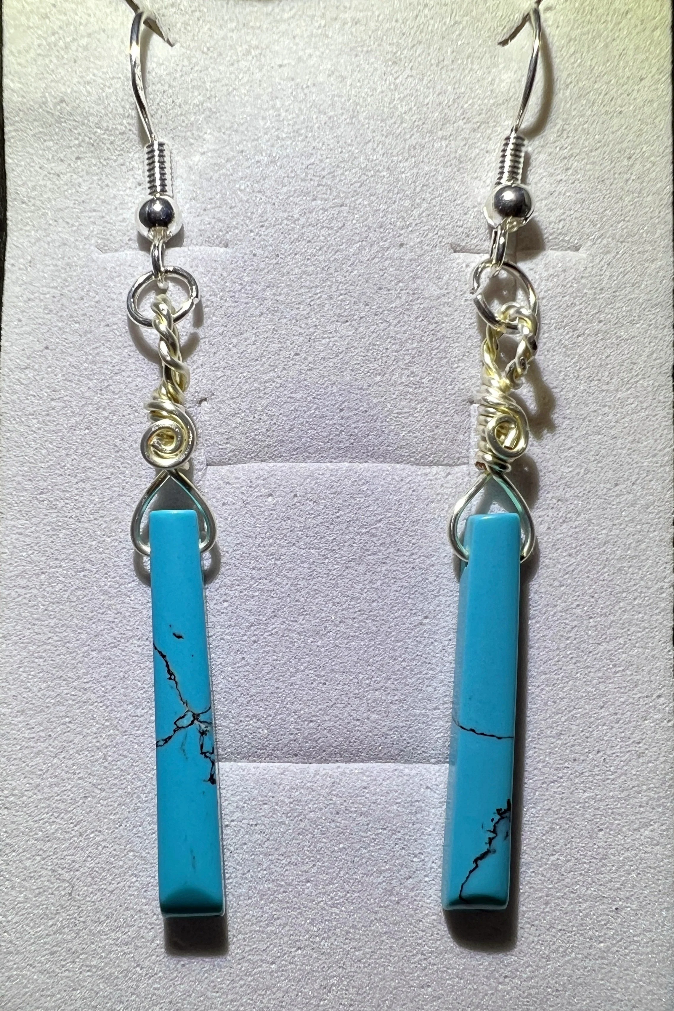 Handmade genuine turquise wire wrapped dangle earrings crafted with nickel free tarnish resistant silver colored wire and sterling silver hooks