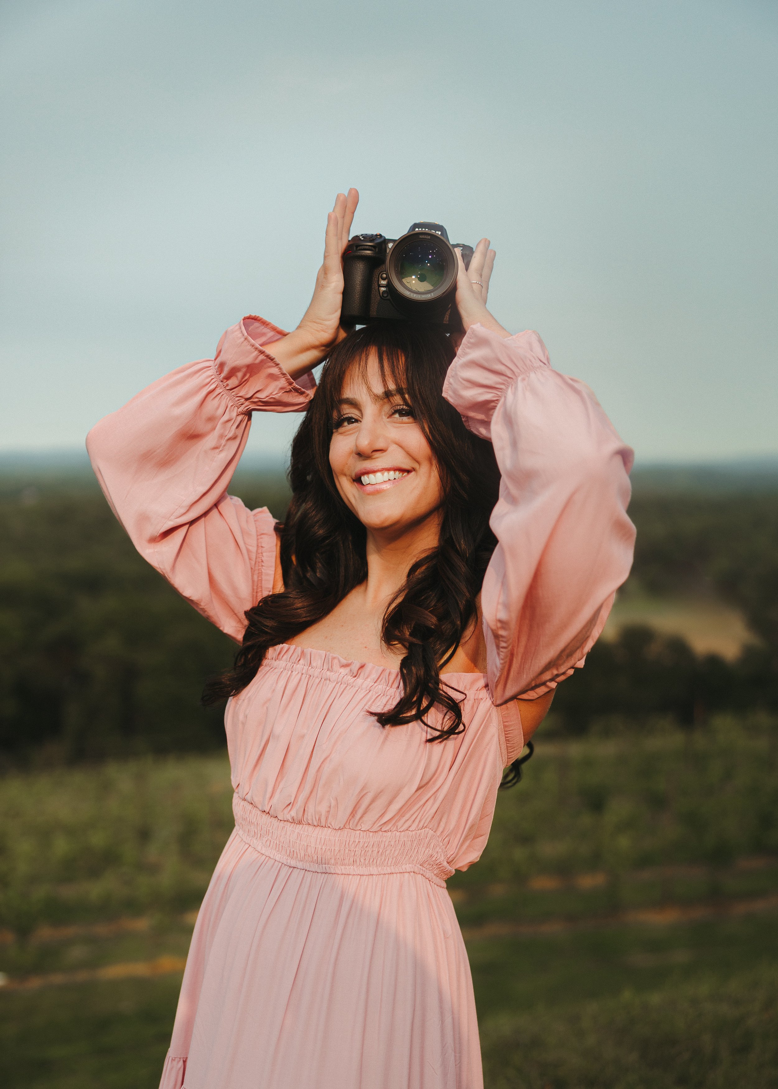 Louisa Vilardi, founder of Hopewell Creative Space, holding a camera