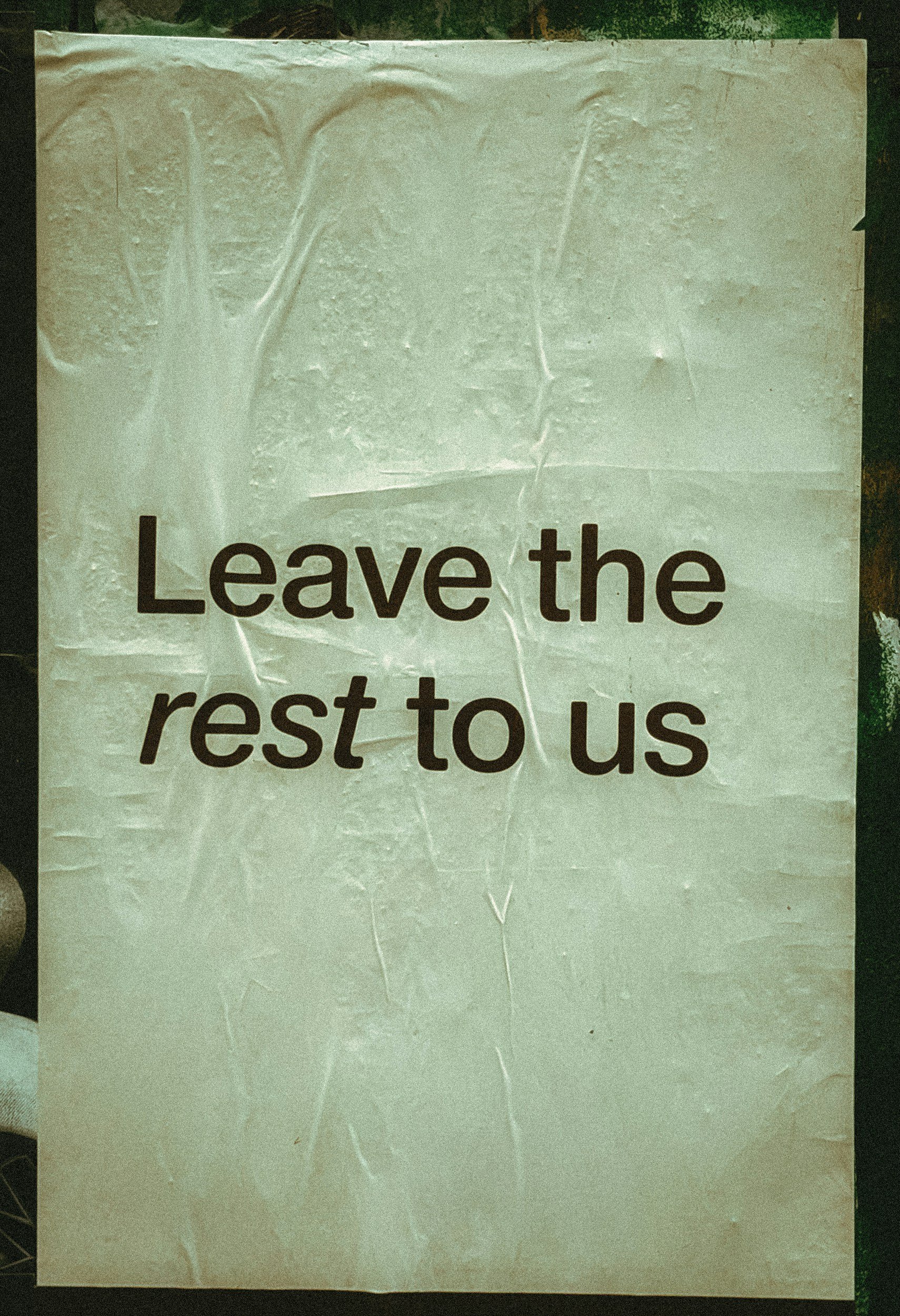 A sign with the text "Leave the rest to us" on it.