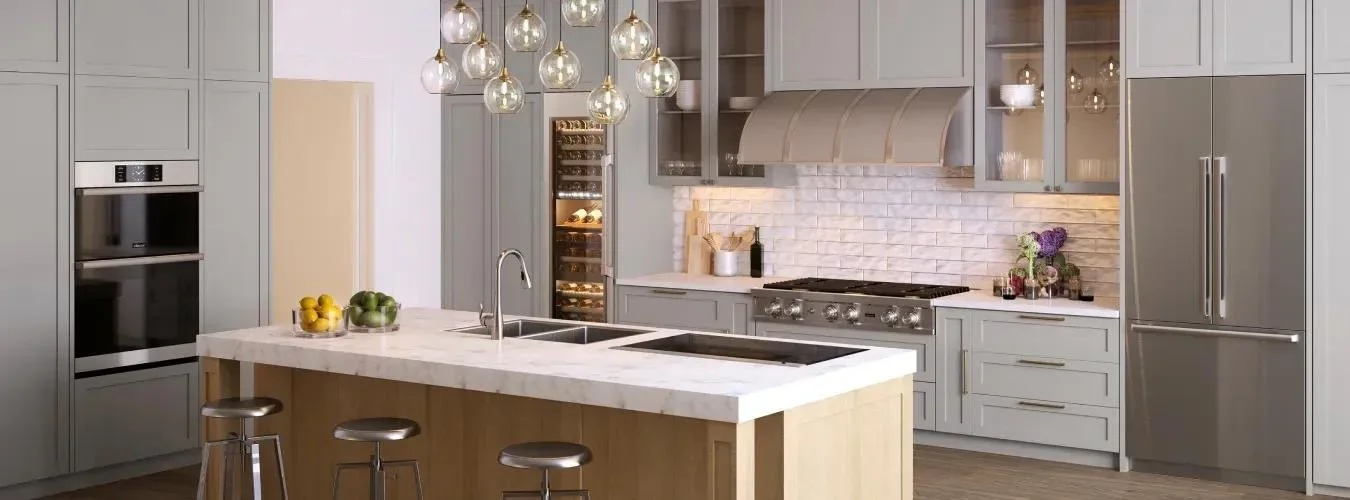 Modern kitchen with gray cabinets, white countertops, and a central island with stools, hanging pendant lights, stainless steel stove, and a refrigerator.
