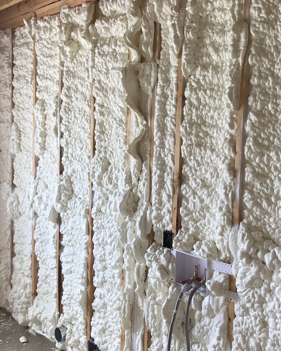 Open cell wall, right after the pass. It keeps expanding past the face of the studs and stays shaggy like this until it gets trimmed back. Drywall doesn't go on until it's flush.
