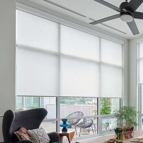 A large office window with motorized light filtering roller shade with valance in Georgetown , Guyana.