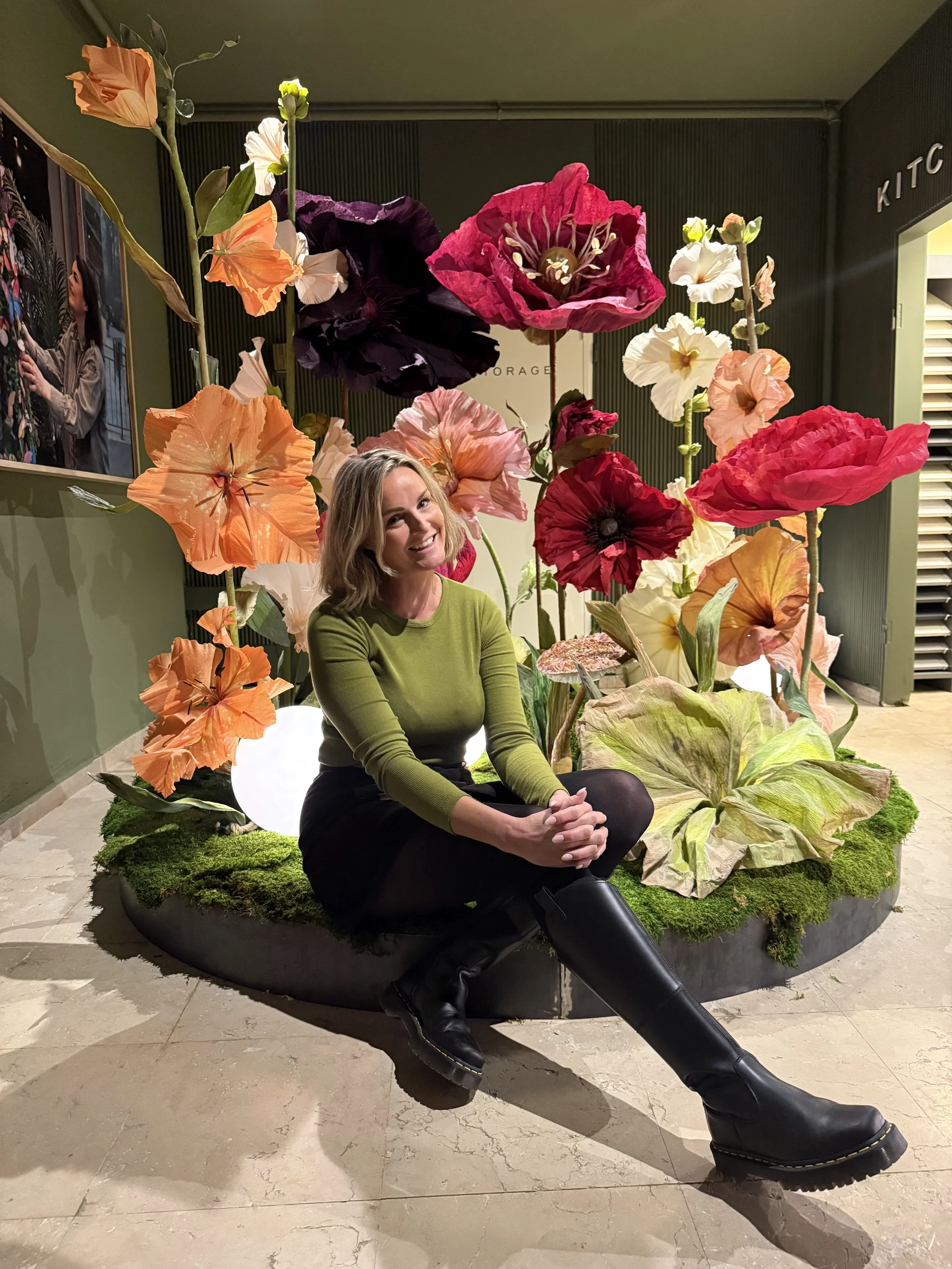 Artist Julia Midtgaard photographed with giant handcrafted paper flower installation.