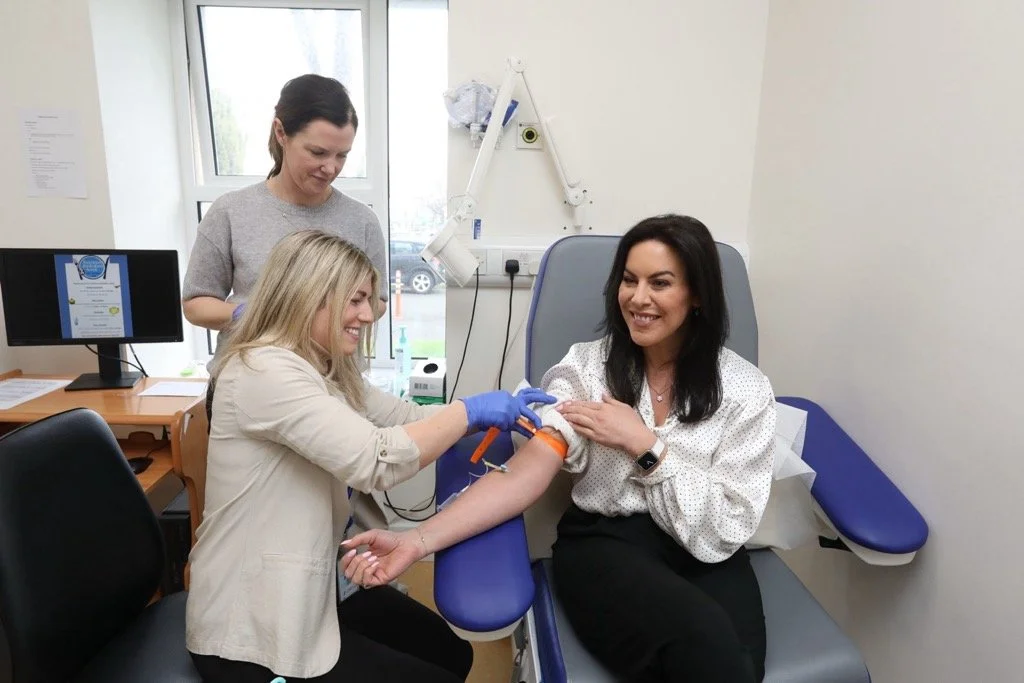 Minister Jennifer Carroll MacNeill TD having a blood pressure taken