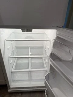 Empty open refrigerator with shelves and door compartments