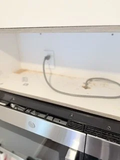 Empty kitchen countertop with a built-in electric stove and a range hood.