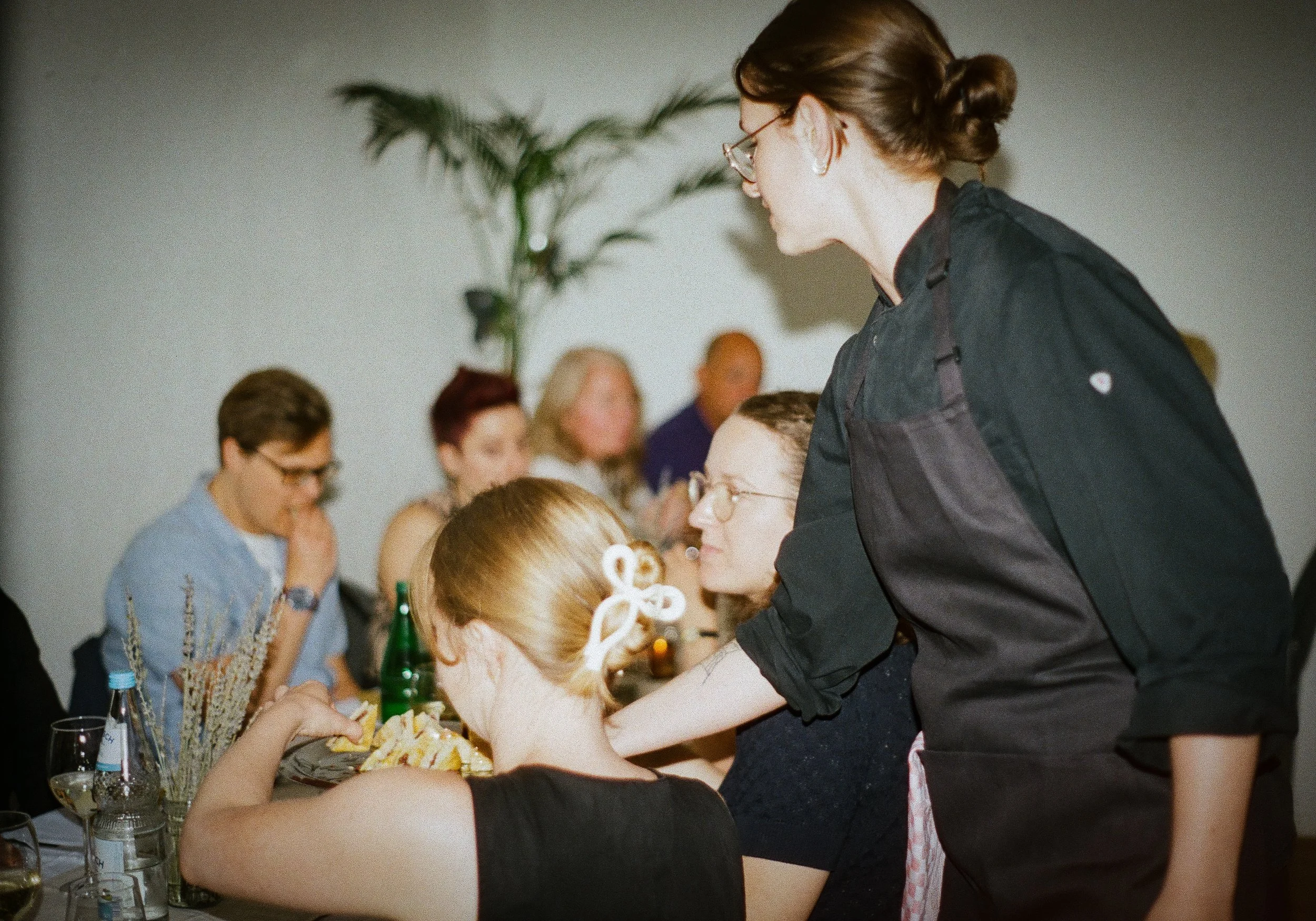 French private chef serving guests during an intimate dining experience in Berlin