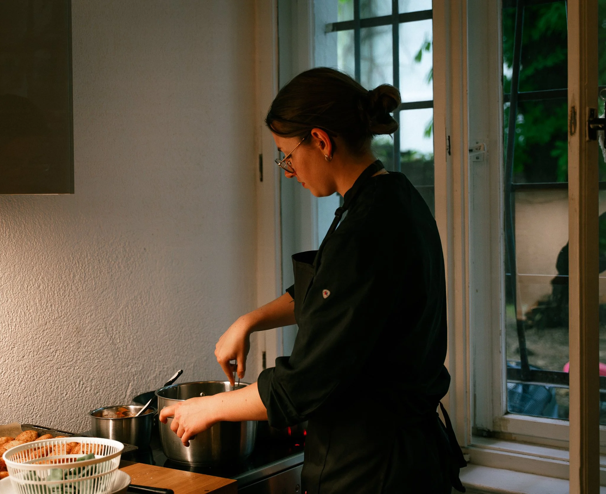 French private chef preparing a seasonal dinner for an intimate experience in Berlin