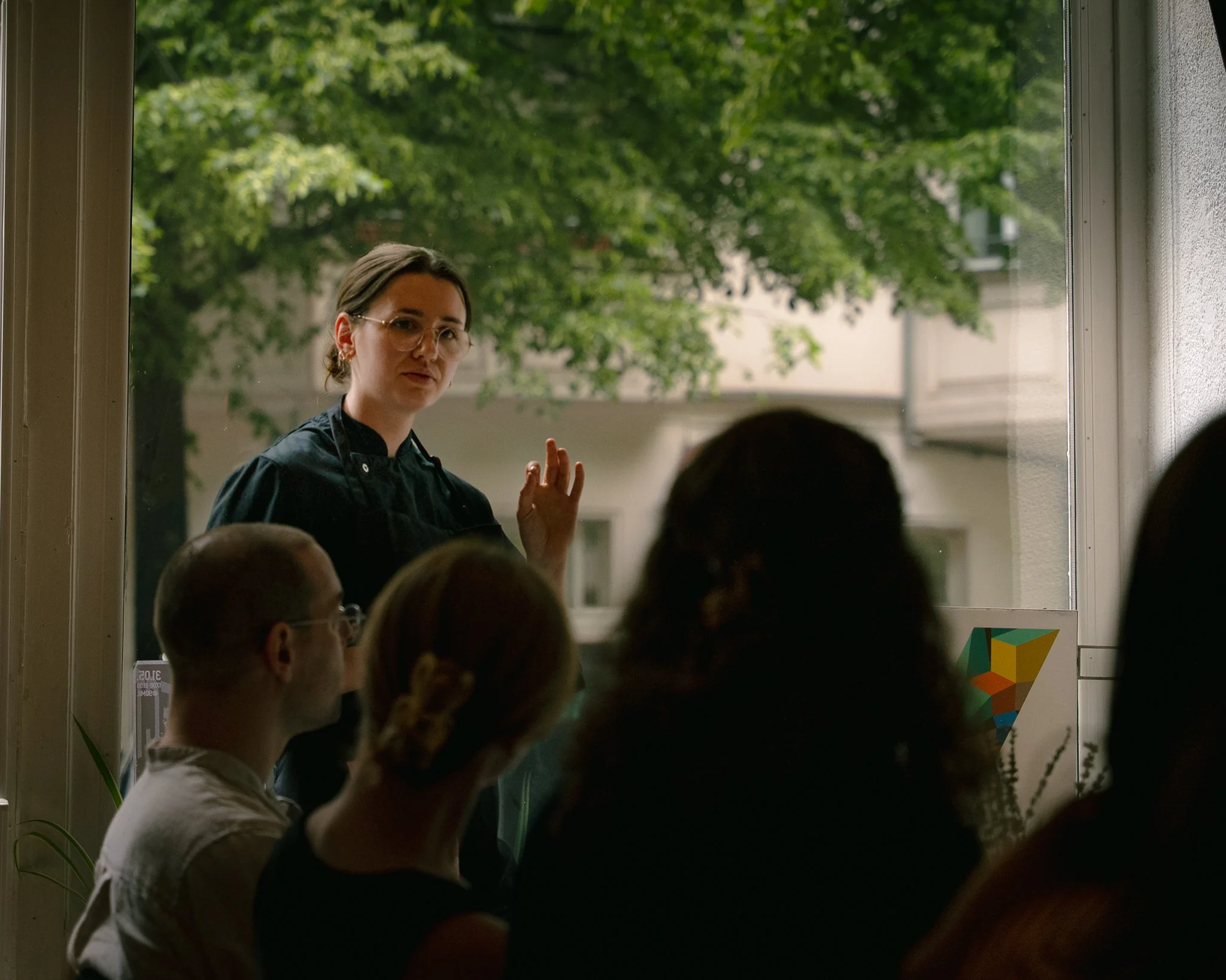 private chef presenting the evening´s menu during an intimate dining experience in Berlin