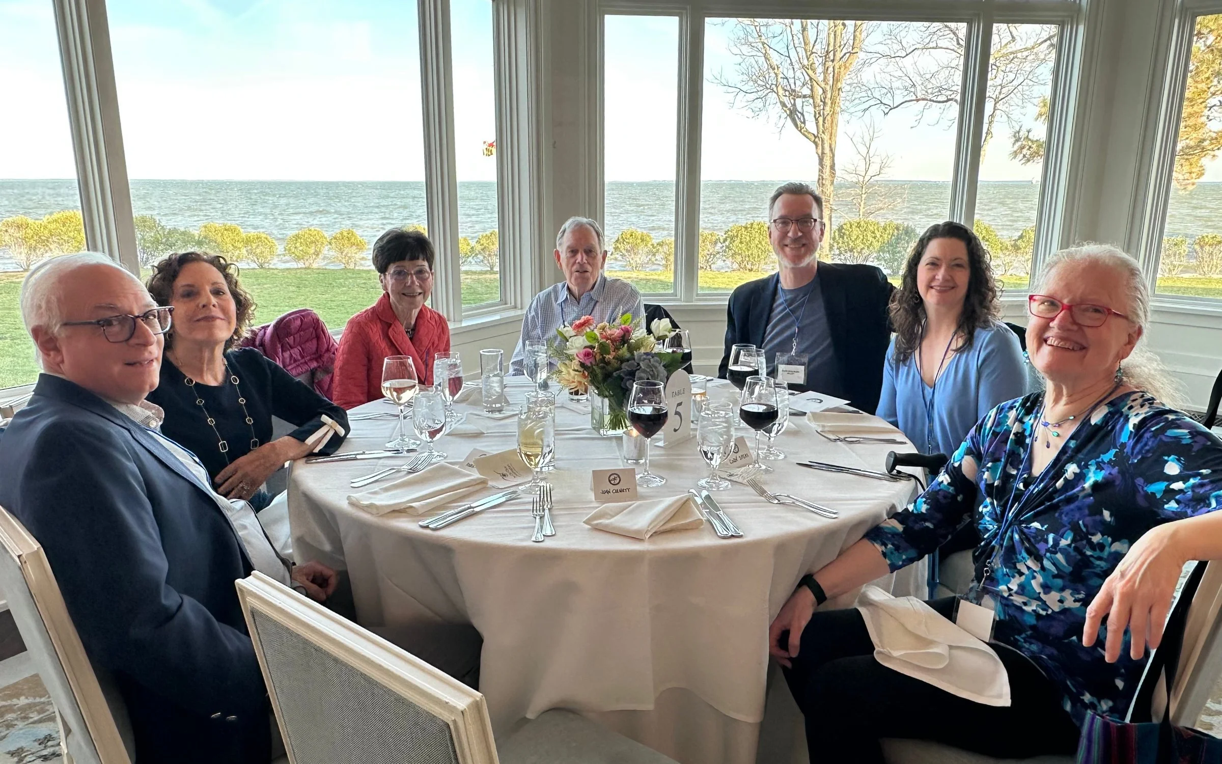 Season Underwriters seated at a table, with Chesapeake Bay in the background.
