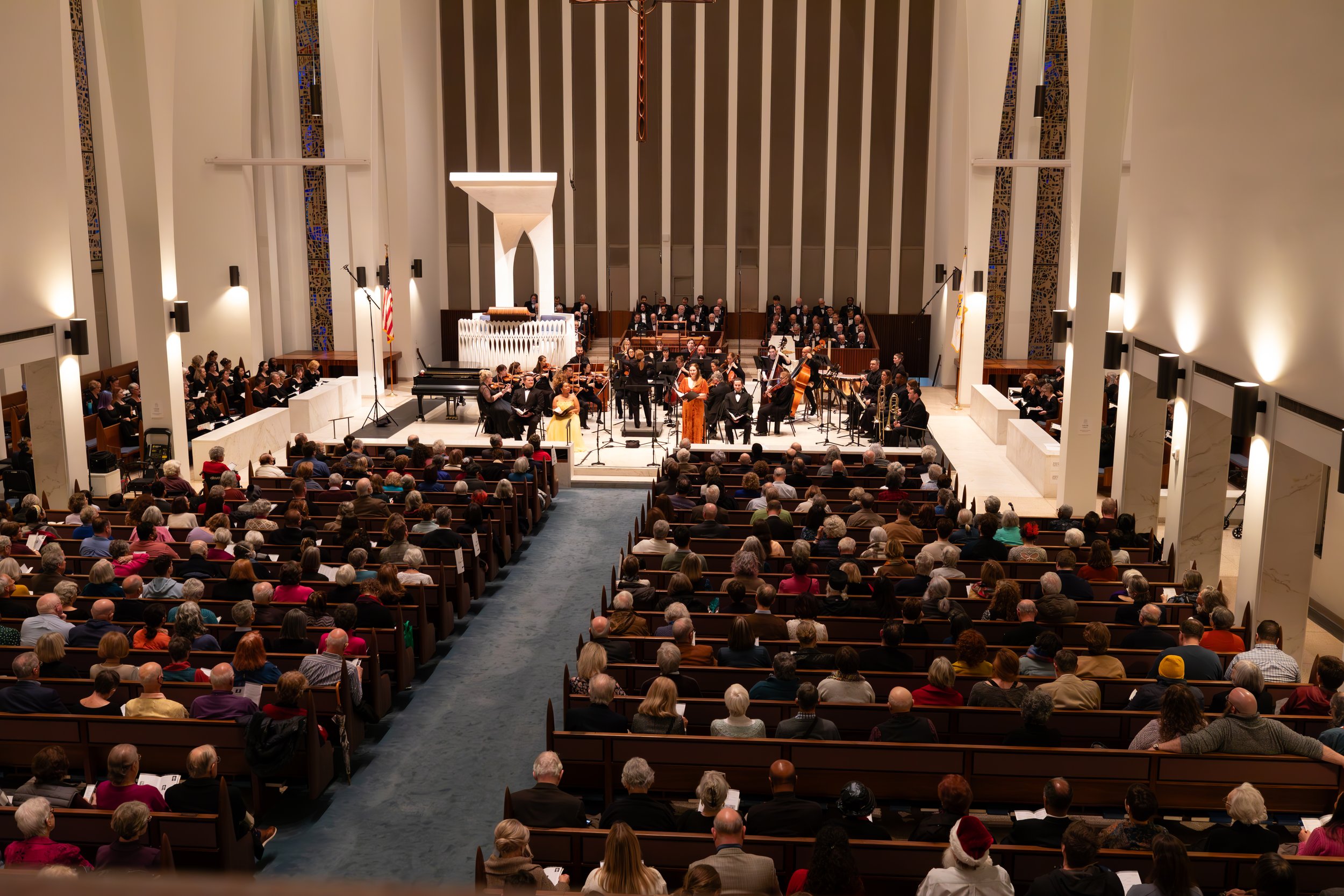 A wide view of the City Choir, orchestra and soloists performing in the sanctuary at National Presbyterian Church.