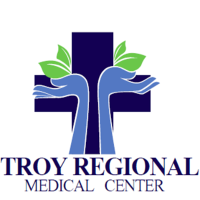 Logo of Troy Regional Medical Center featuring a blue cross with hands and leaves