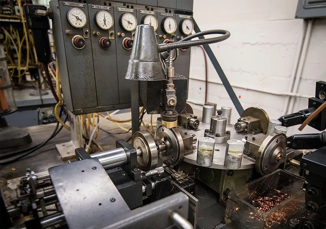 Close-up of a precision machine tool with gauges and metal components in an industrial setting.