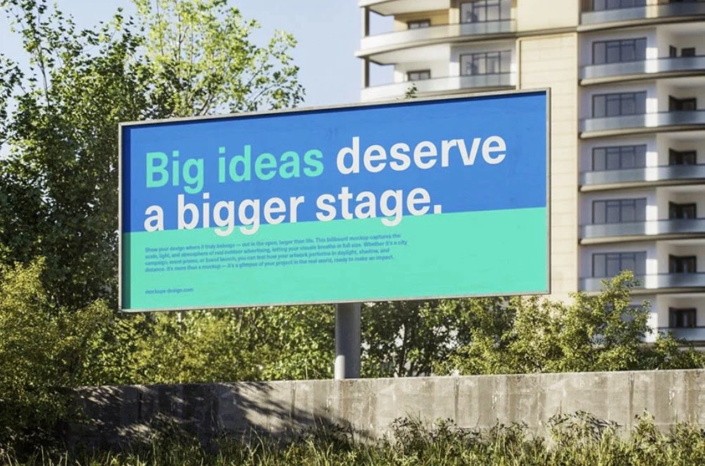 Outdoor billboard with a blue and green typographic design.