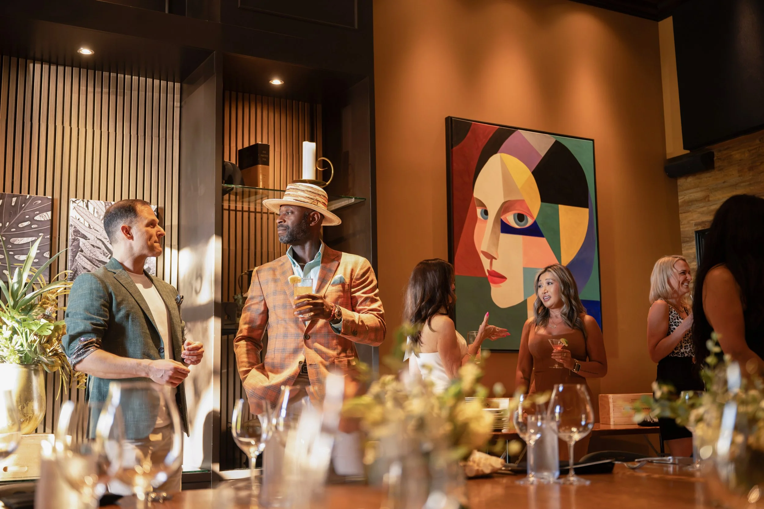Guests socializing during a hosted cocktail reception in The Annex with bar service and appetizers.